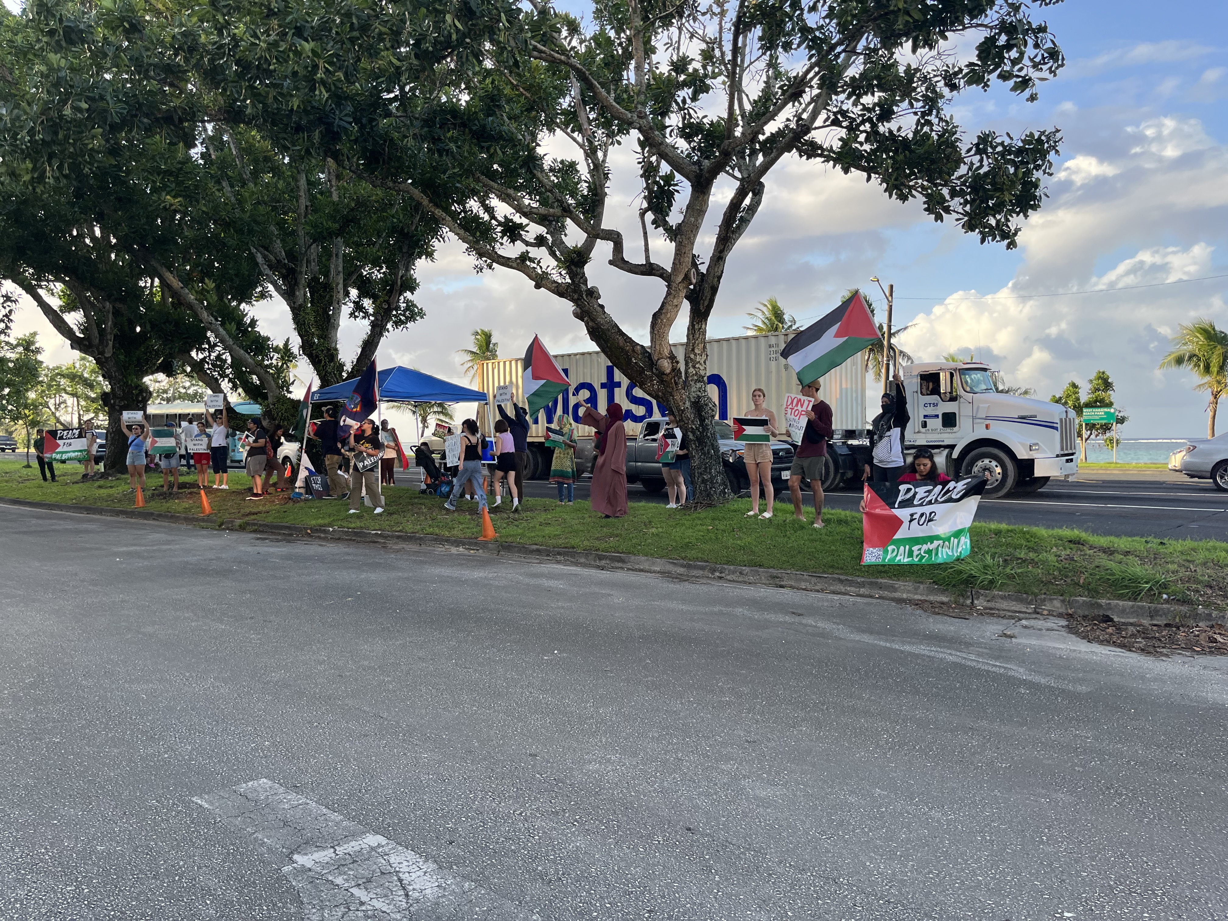 Protestors with Marianas for Palestine wave Palestinian flags outside the office of Guam's delegate to the U.S. Congress, James Moylan, on Nov. 14, 2023.