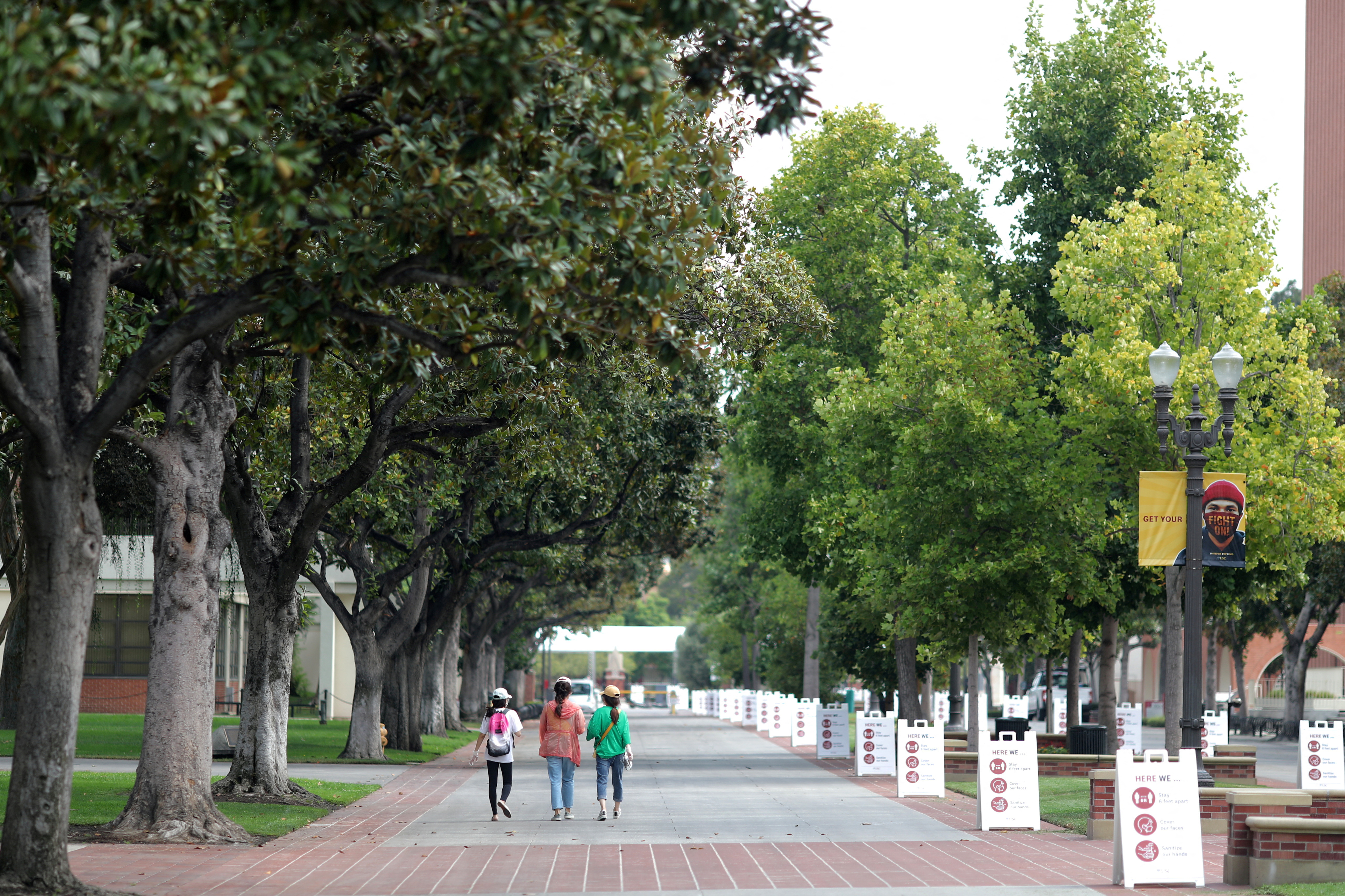 People walk on an empty University of Southern California (USC) campus, August 17, 2020.