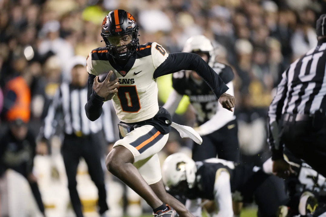 Oregon State quarterback Aidan Chiles runs for a touchdown against Colorado in the first half of an NCAA college football game Saturday, Nov. 4, 2023 in Boulder, Colo.