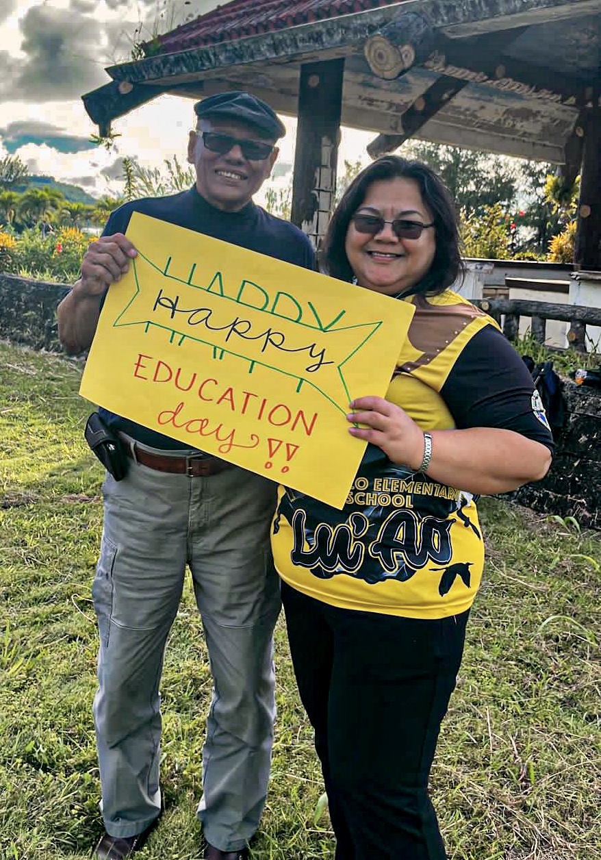 BOE Vice Chairman Herman Atalig and Sinapalo Elementary School Principal Daisy Quitugua hold a “Happy Education Day” sign as they joined the Rota public education stakeholders’ roadside waving activity near Pinatang Park.