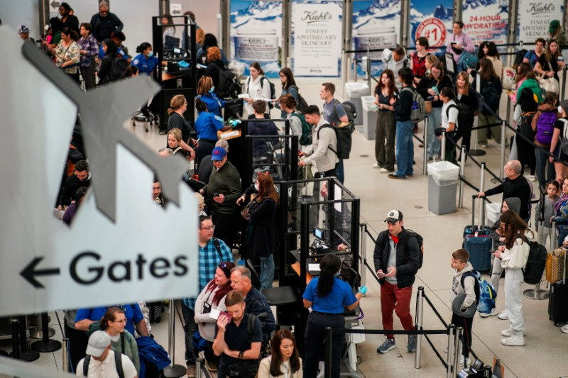 Travelers wait at John F. Kennedy International Airport in New York City, U.S., April 6, 2023. 