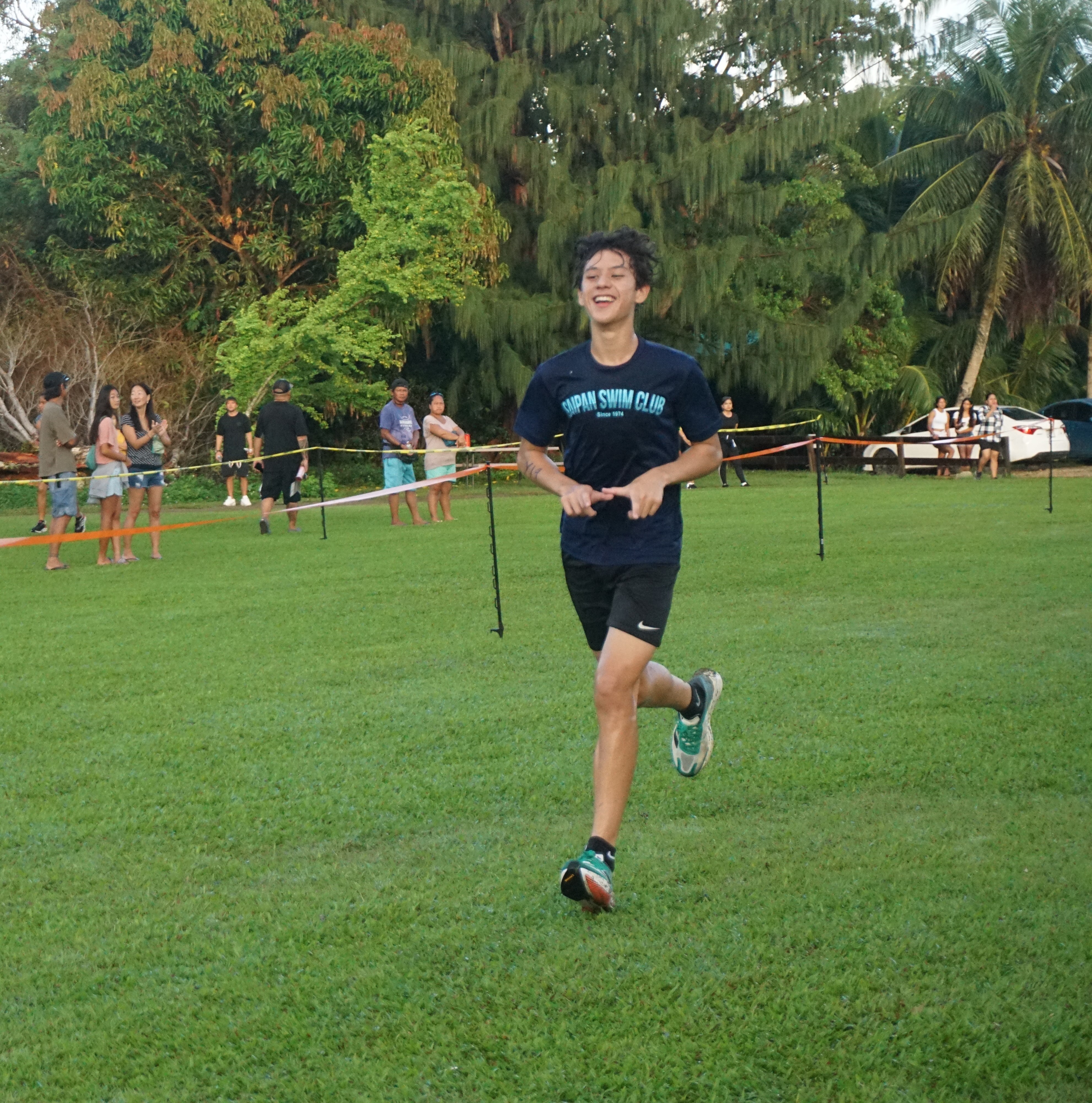 Michael Miller smiles as he finishes first in the boys high school division of the PSS-NMA All School Cross Country Series SY23-24 on Saturday at the Saipan Country Club of Saipan Vegas.