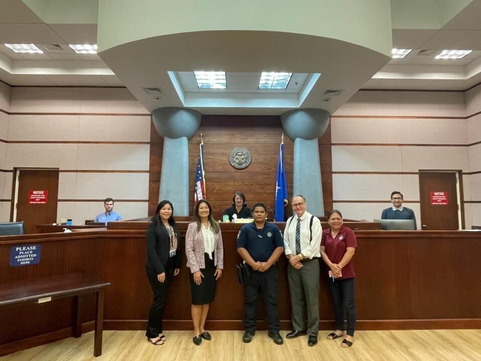 On Nov. 7, 2023, the NMI judiciary held its first Family Court night session in the Guma’ Hustisia, Courtroom 217 with Associate Judge Teresa K. Kim-Tenorio presiding. From back left: Law Clerk James Hallisey, Associate Judge Teresa K. Kim-Tenorio and Deputy Clerk I Gregorio Tudela. From front left: Acting Family Court Manager Roxanne Torres, Attorney Janet King, Deputy Marshal III Roemar Segotier, Assistant Attorney General Tom Schweiger, and Division of Youth Services Caseworker Christine Aldan.