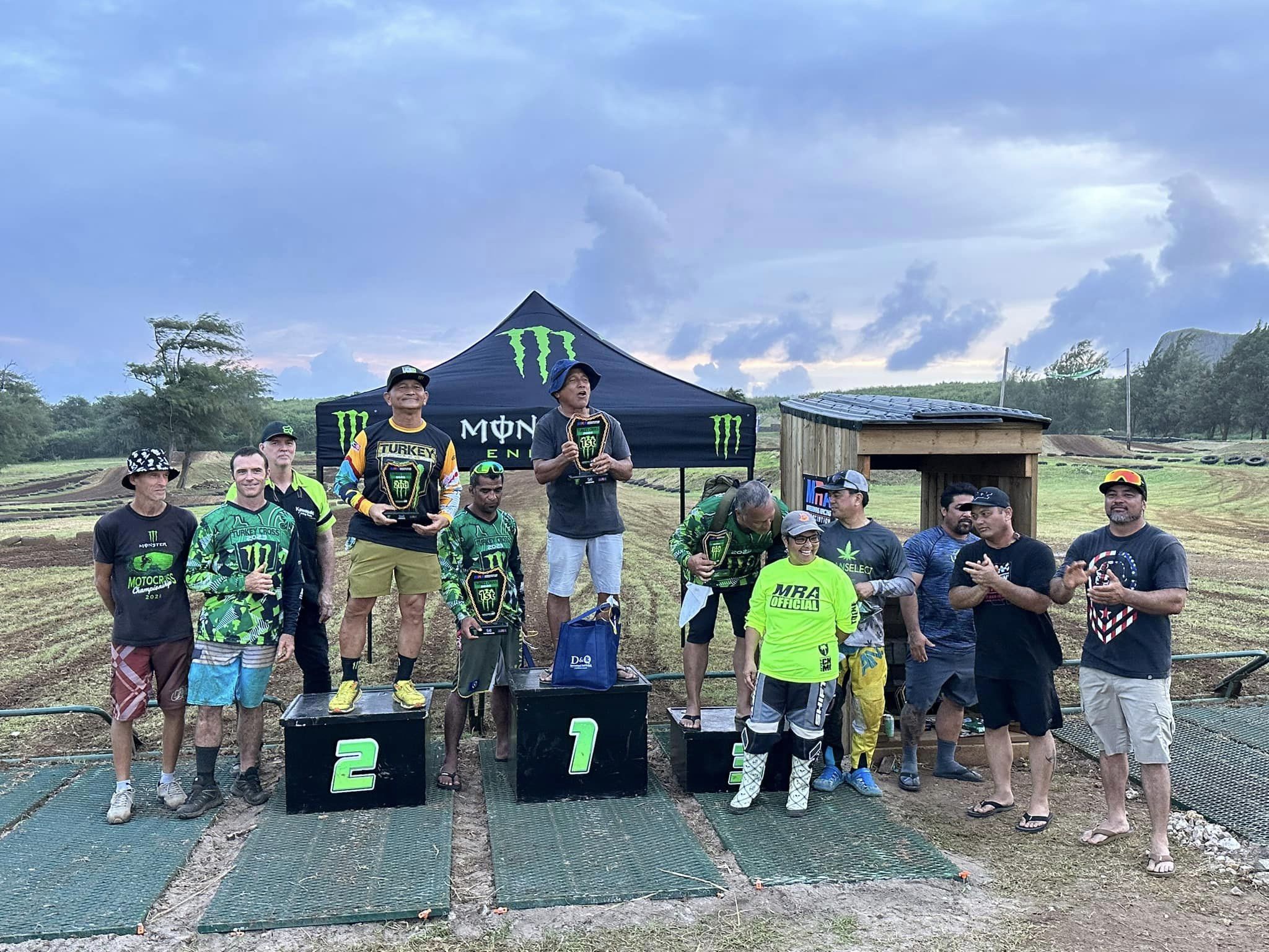 The top 3 of the Legends Class: Franklin Rios, center, Jeffrey Rios, left, and Charles Cepeda, pose for a photo with their trophies alongside Marianas Racing Association officers and members during the awards ceremony of the 2023 MRA Turkey Cross held over the weekend at the Cow Town Raceway Park.
