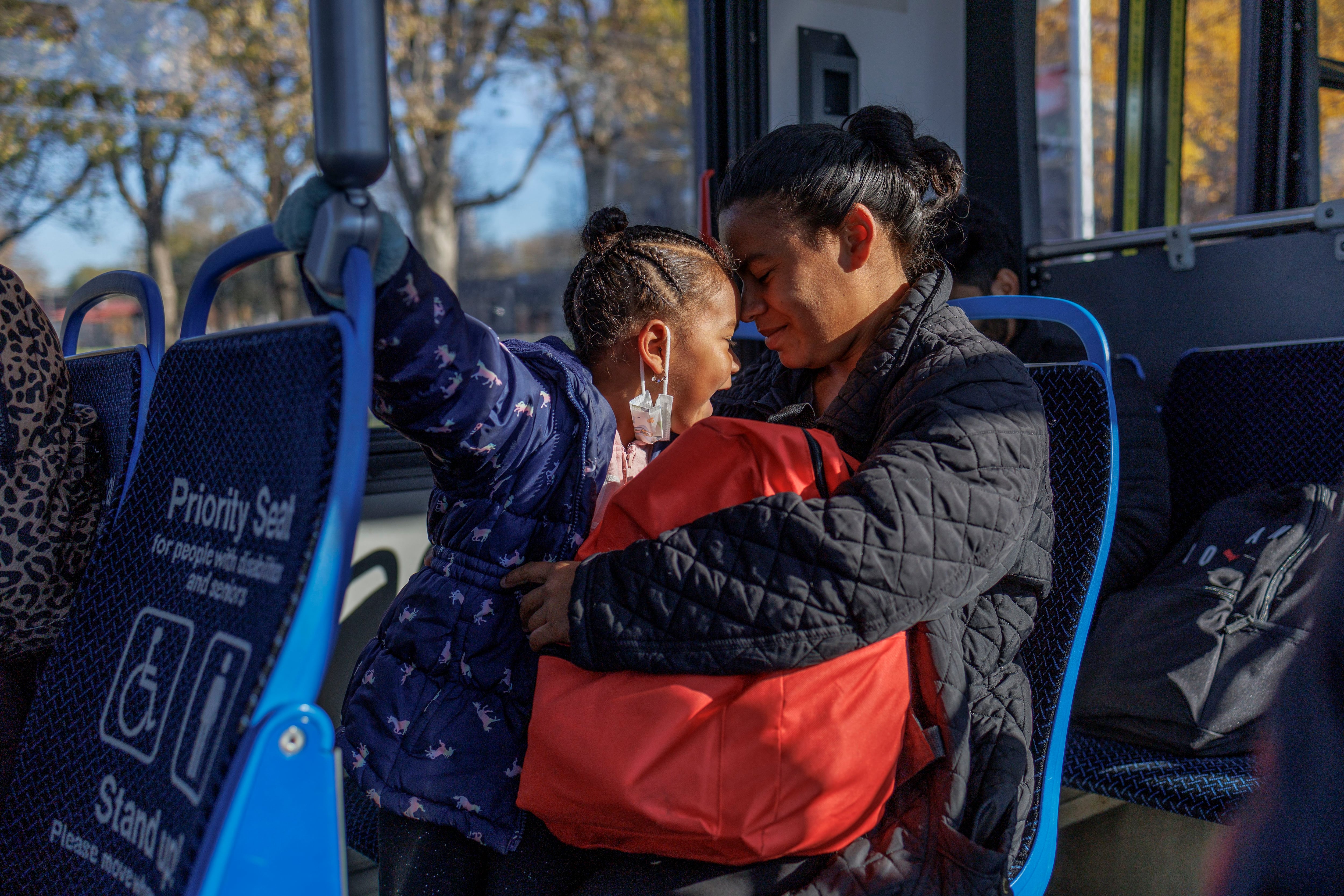 Jessana Malaue, 27, and her 4-year-old daughter, Jessmar, ride a bus from their migrant shelter near Pilsen to buy food at a WIC grocery on West Cermak Road on Nov. 10, 2023.