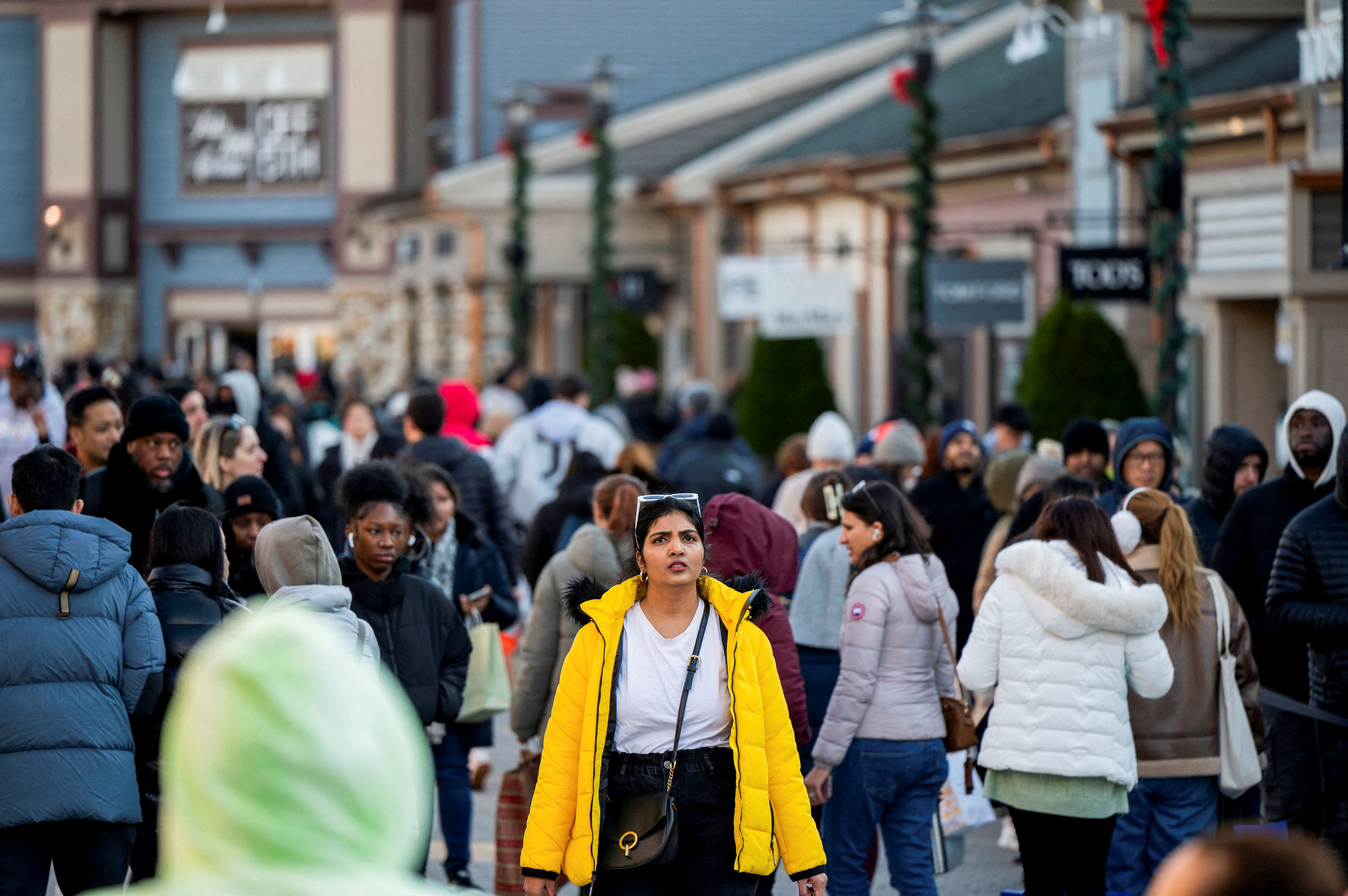 Black Friday shoppers walk to stores as retailers compete to attract shoppers and try to maintain margins on Black Friday, one of the busiest shopping days of the year, at Woodbury Common Premium Outlets in Central Valley, New York, U.S. November 24, 2023. 
