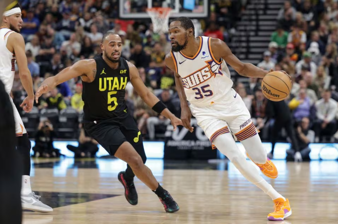 Phoenix Suns forward Kevin Durant (35) is chased by Utah Jazz guard Talen Horton-Tucker (5) while dribbling during the second quarter at Delta Center in Salt Lake City, Utah,  Nov. 19, 2023.