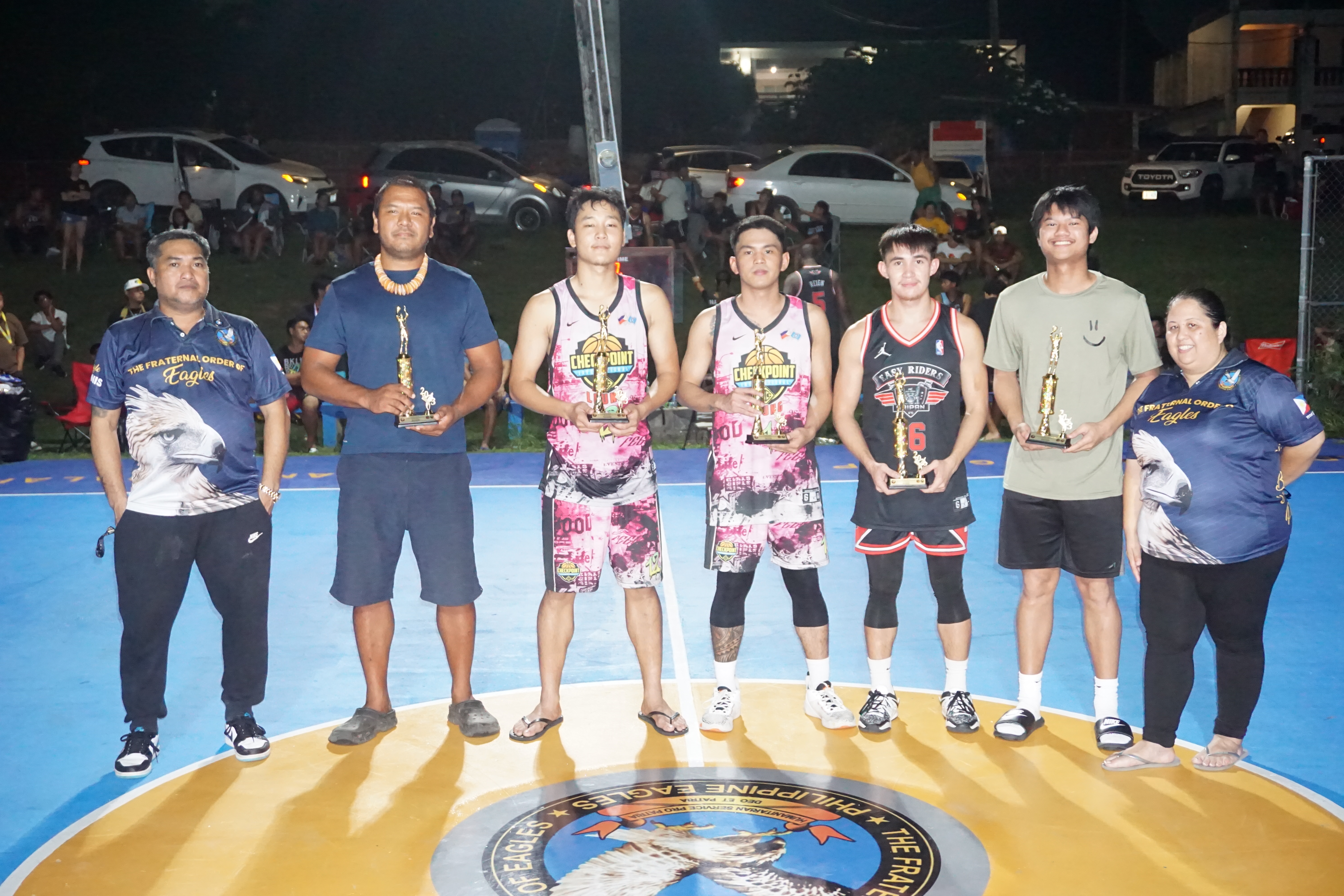 The open division Mythical Five players pose for a photo with the 2023 Saipan Magalahi Eagles Club Invitational Basketball League officials during the awards ceremony Saturday at the Gualo Rai basketball court.