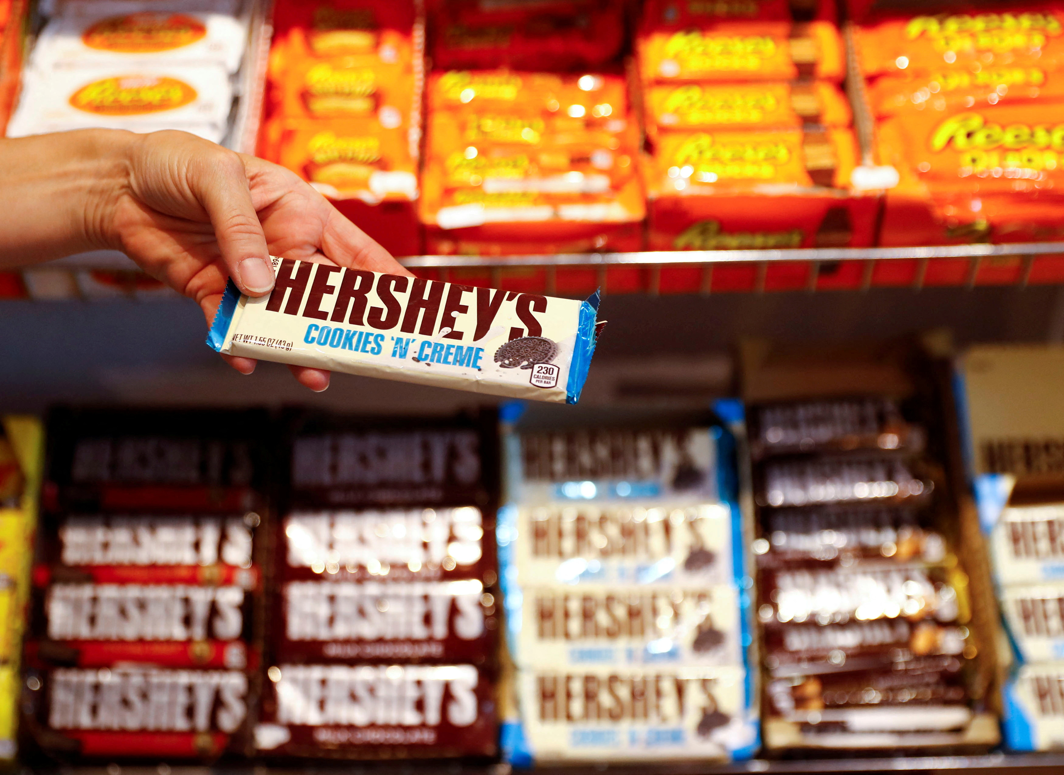 An employee shows a Hershey's chocolate bar made in USA in the "American lifestyle" store in Berlin, Germany, August 13, 2018. 