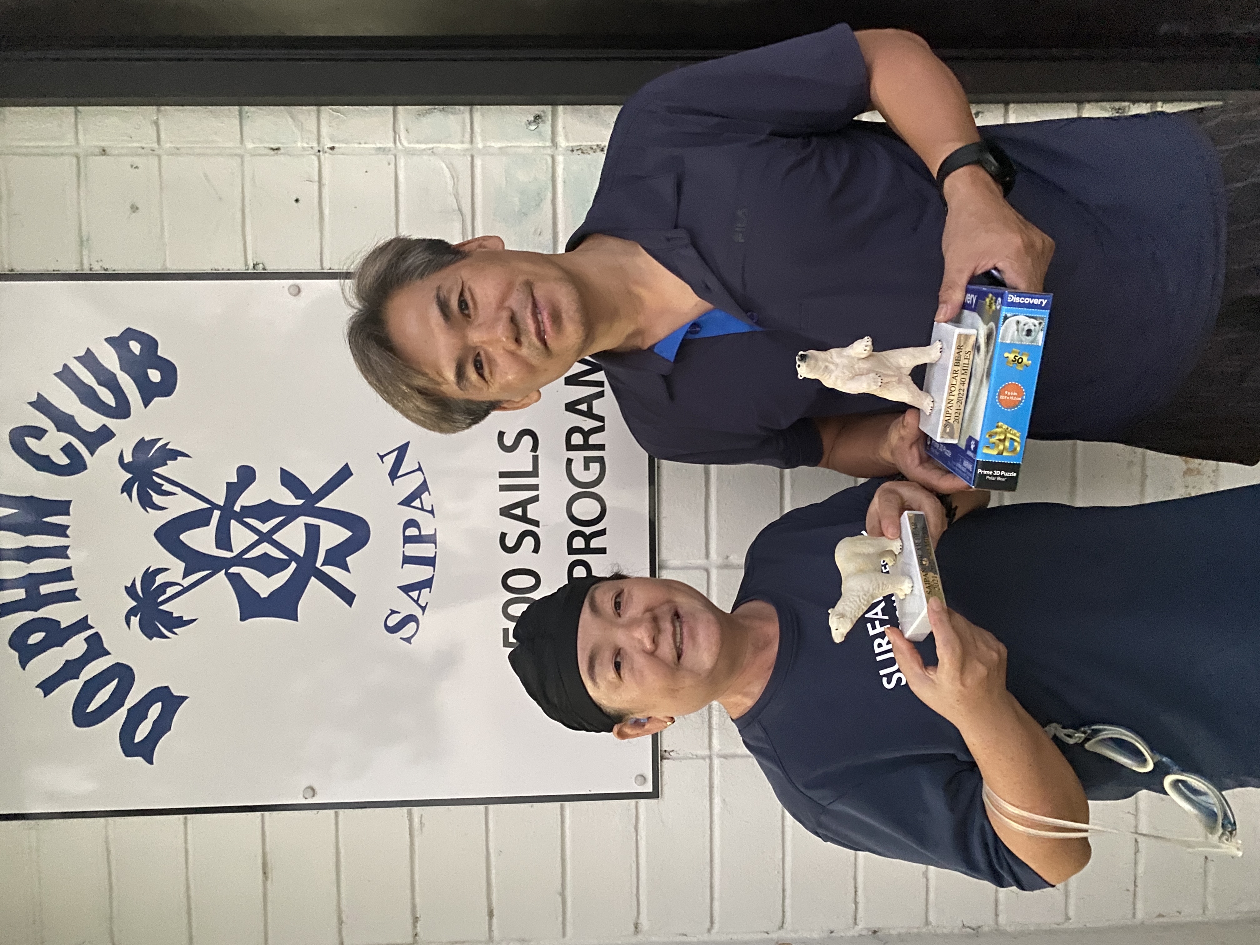 In this file photo, Bok Sun Hwang, left, and Iek Hun Ahn pose with the polar bears they received after completing the 500 Sails and Dolphin Club Saipan Polar Bear Swim from 2021-2022.