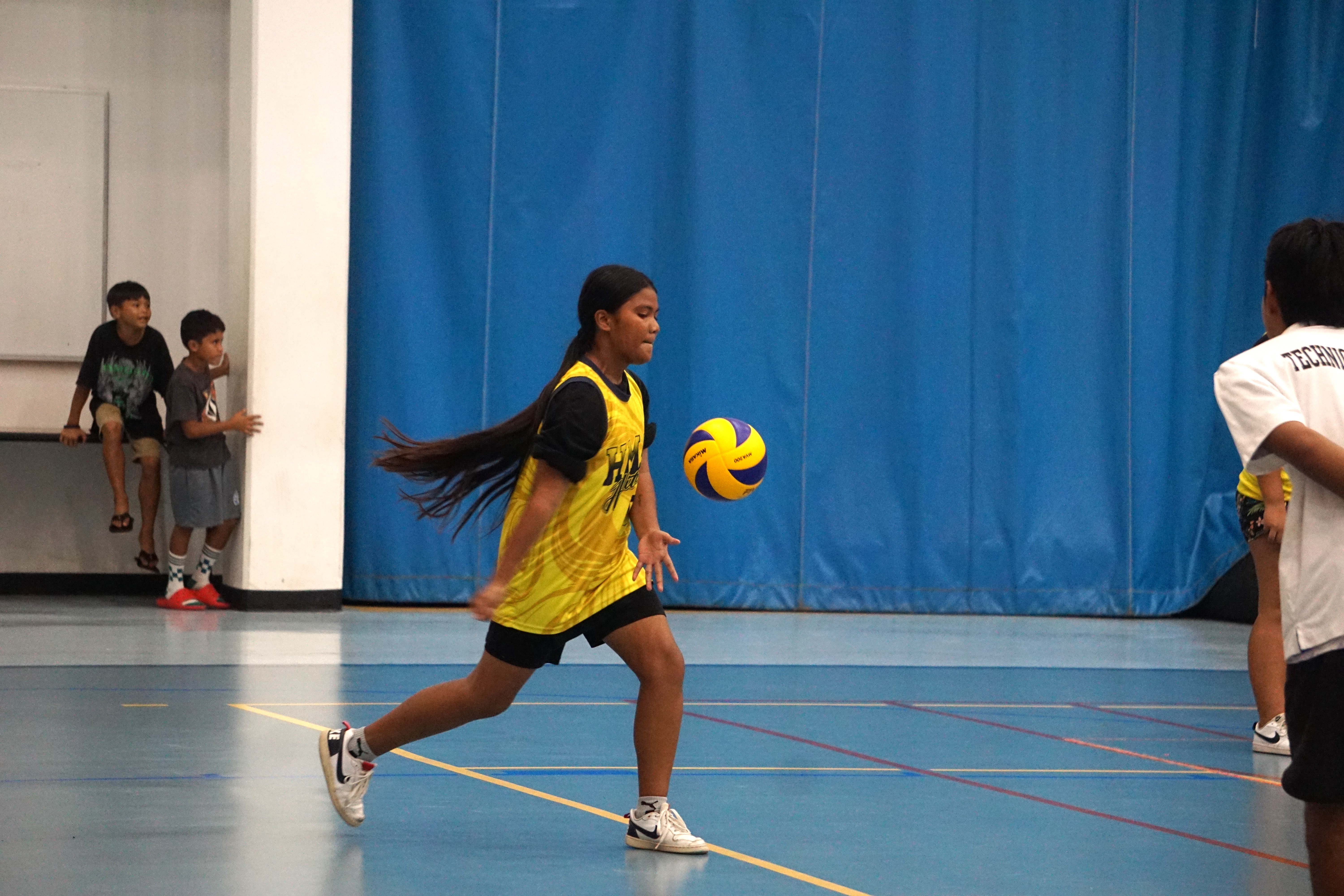 A Hopwood Middle School II player attempts an underhand serve during a girls middle school division game of the PSS-NMIVA Interscholastic Volleyball League SY23-24 at the Marianas High School gym.