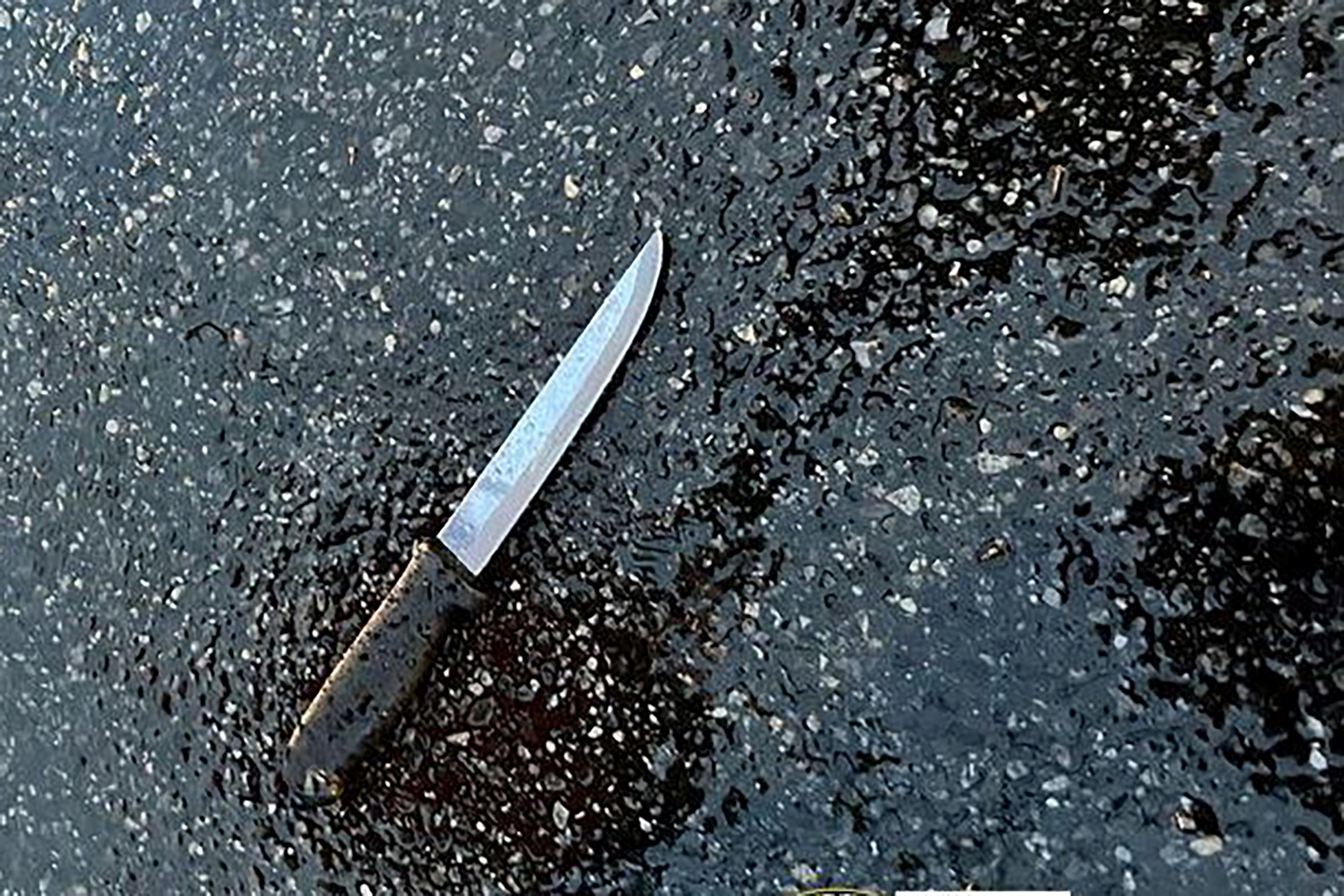 A knife found at the scene lies on pavement after a man, who was later shot dead by police, killed four members of his extended family, including two children, and stabbed two police officers at a home in the Queens borough of New York City, U.S. December 3, 2023. 