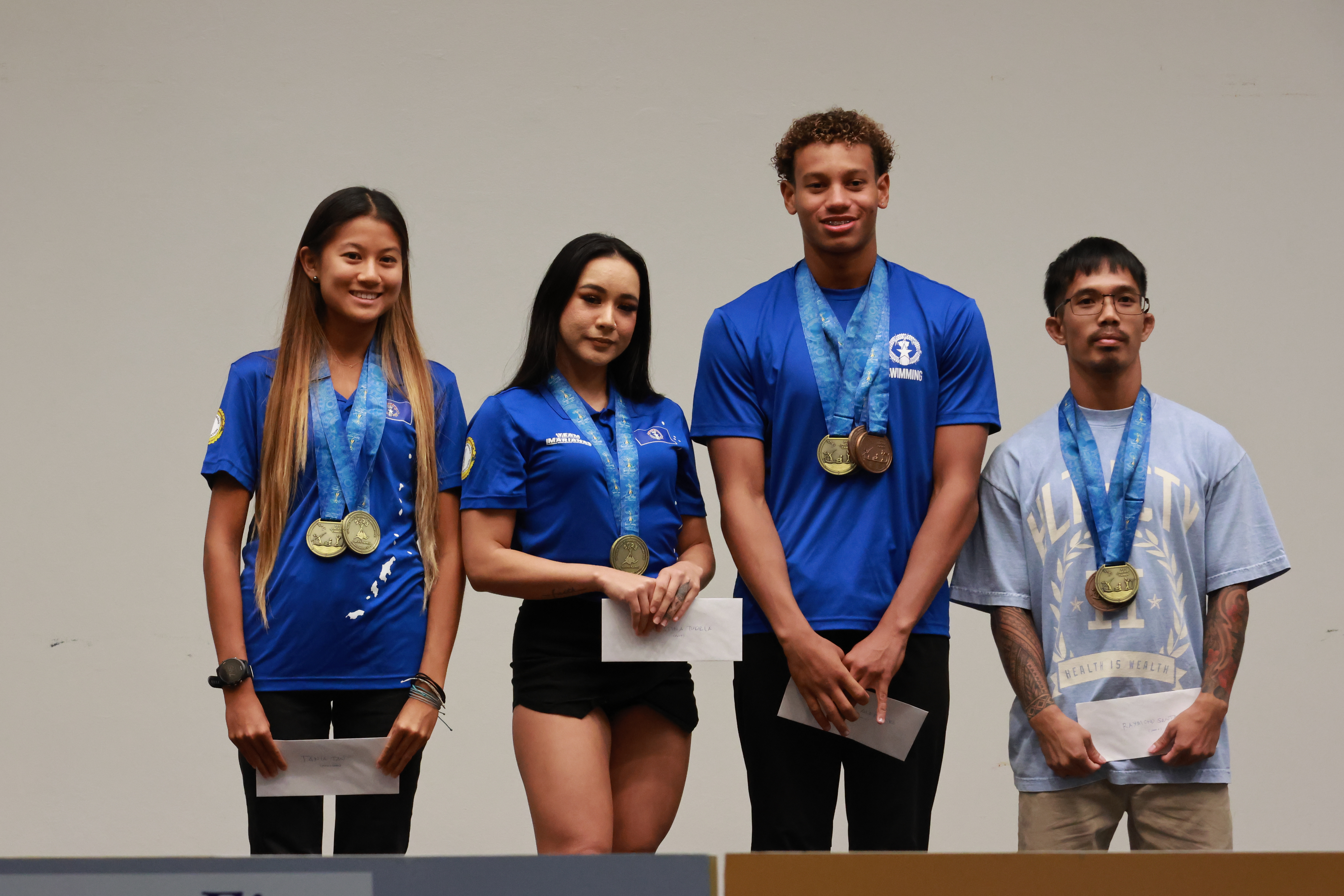 Pacific Games 2023 gold medalists Tania Tan, from left, Christina Tudela, Isaiah Aleksenko, and Raymond Santos pose for a photo during Team Marianas Appreciation Night at the Hibiscus Hall of Crowne Plaza Resort Saipan on Tuesday.