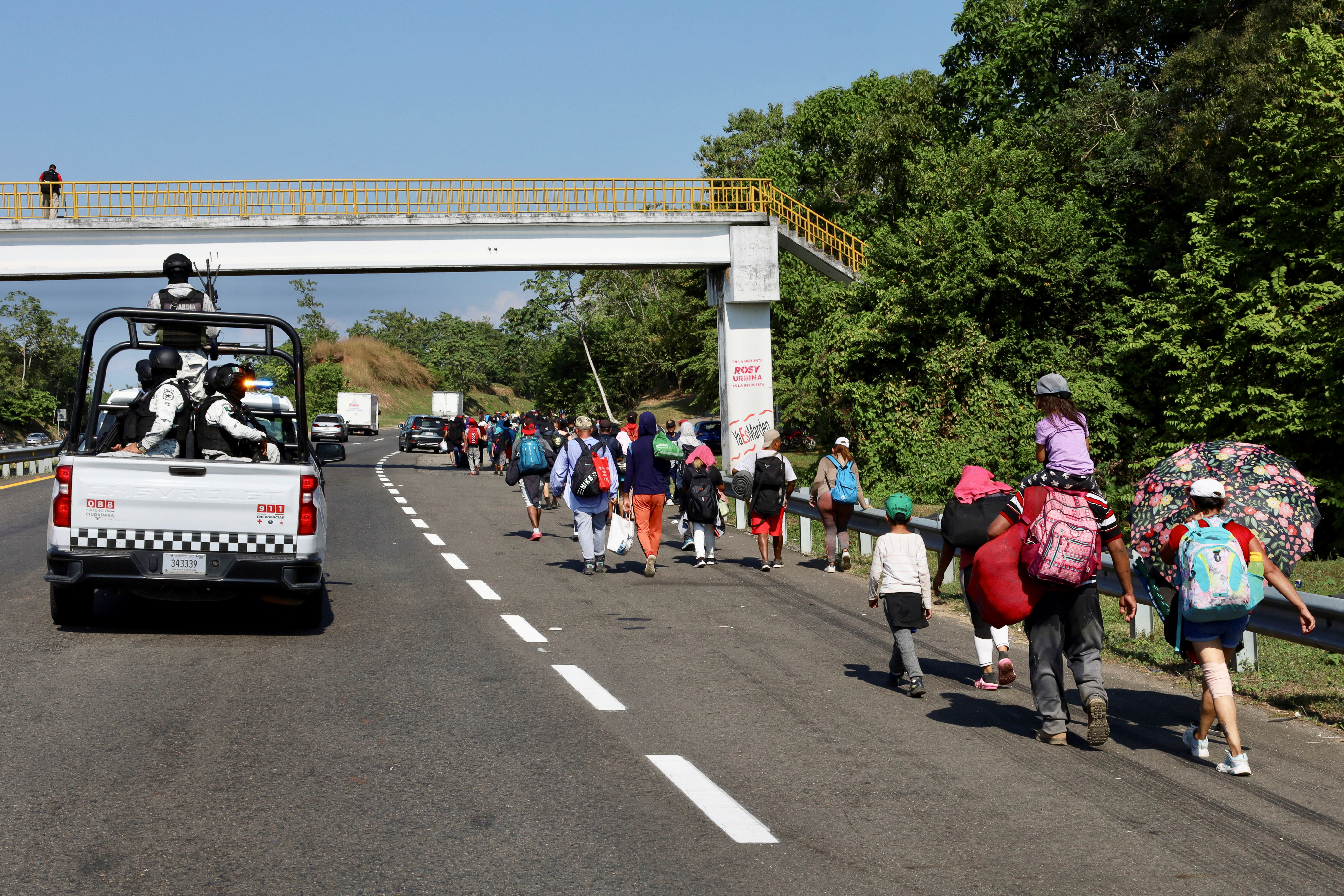 Migrants walk in a caravan as an attempt to reach the U.S. border, in Huixtla, Mexico December 26, 2023. 