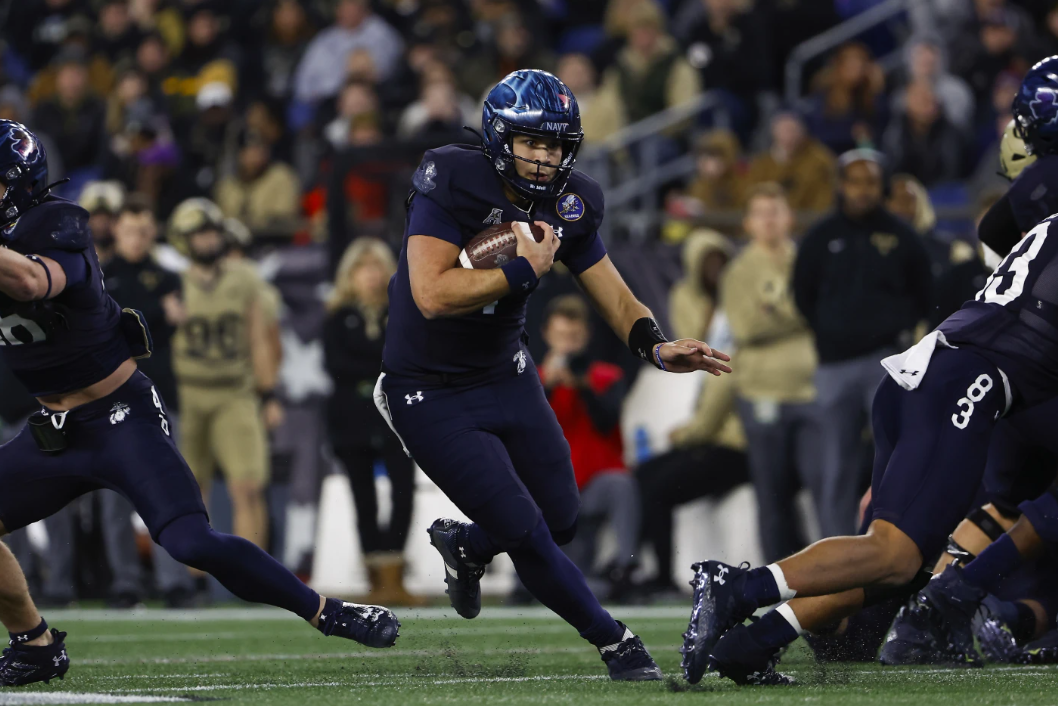 Navy quarterback Xavier Arline runs through a hole in the Army defense during the second quarter of an NCAA football game at Gillett Stadium Saturday, Dec. 9, 2023 in Foxborough, Mass.