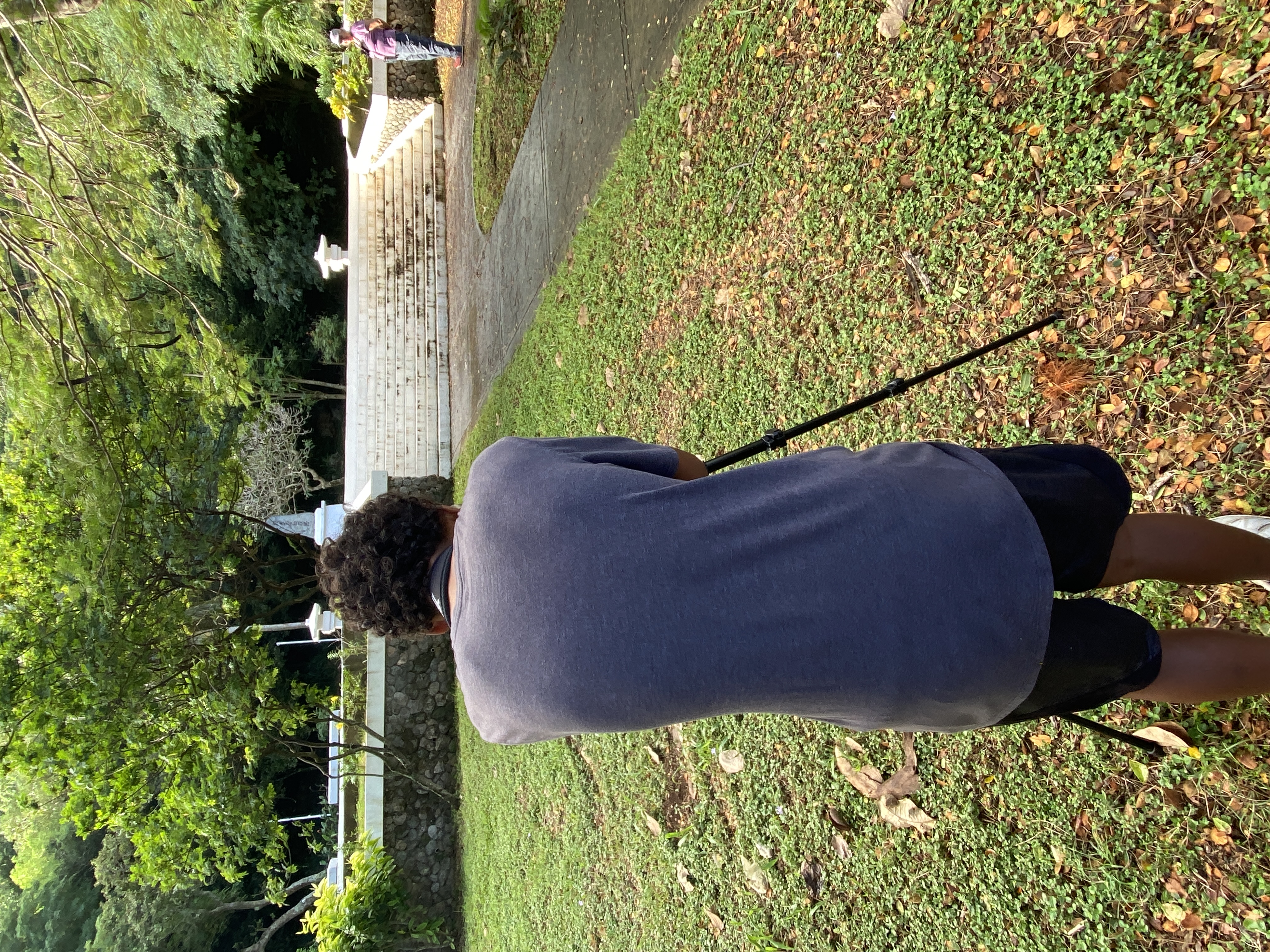 A student from Tanapag Middle School observes a collared kingfisher that landed on a plumeria tree.