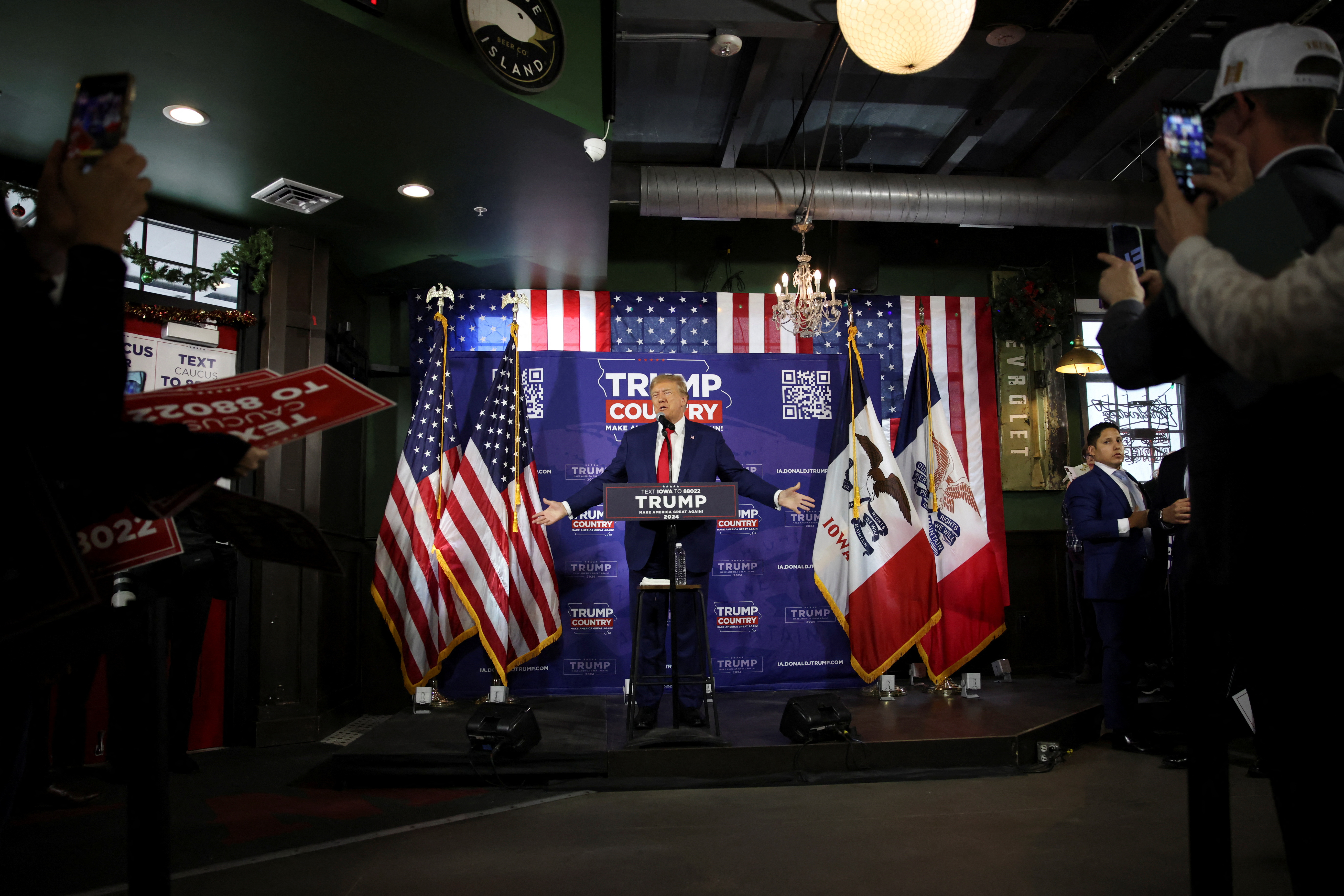 Former U.S. President and Republican presidential candidate Donald Trump rallies with supporters at a "commit to caucus" event at a Whiskey bar in Ankeny, Iowa, U.S. December 2, 2023. 