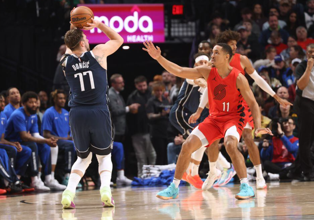 Dallas Mavericks guard Luka Doncic (77) shoots the ball over Portland Trail Blazers guard Malcolm Brogdon (11) in the first half at Moda Center in Portland, Oregon, Dec. 16, 2023.
