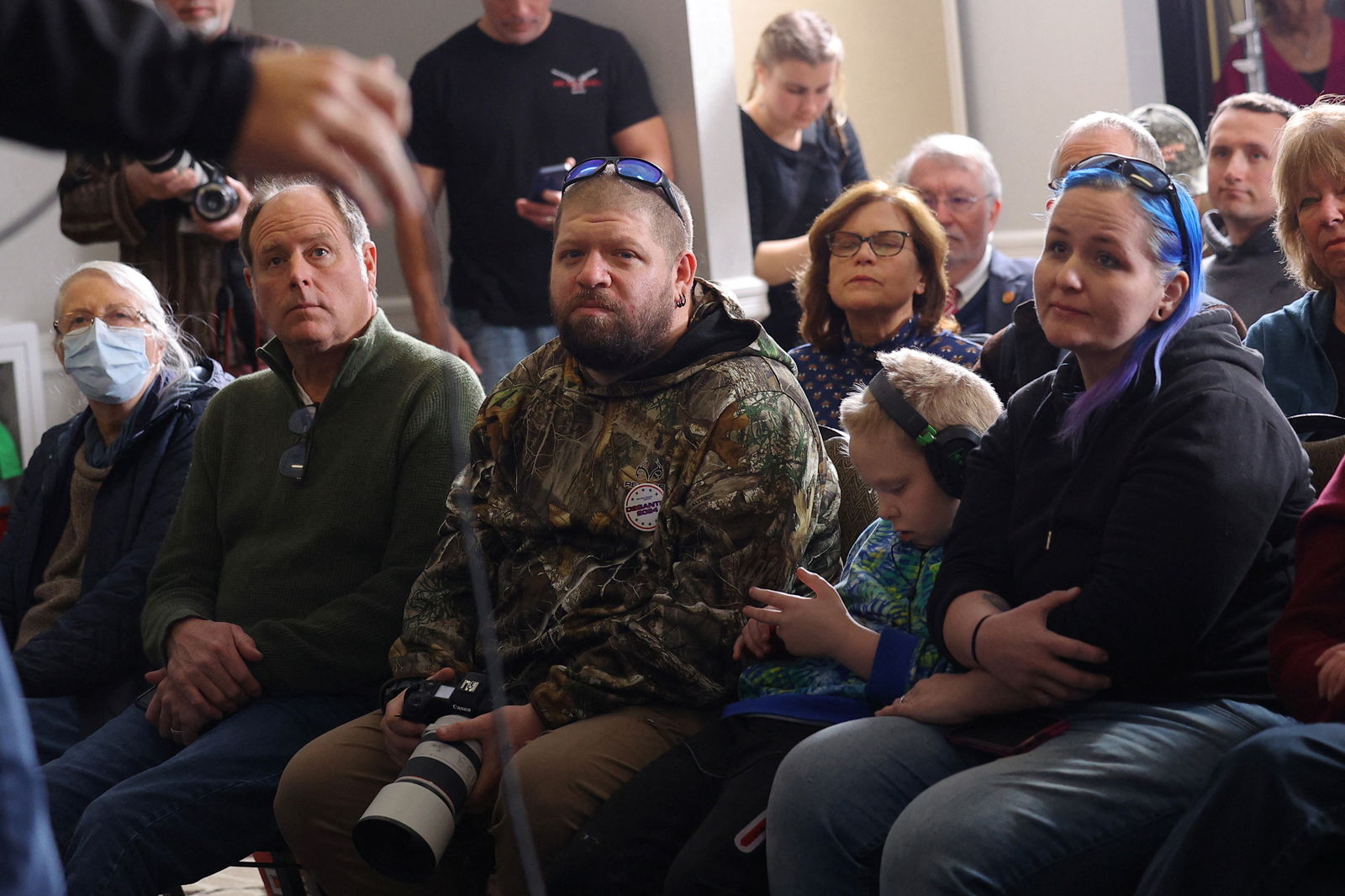 Audience members listen as Republican presidential candidate Florida Governor Ron DeSantis speaks at a Never Back Down campaign stop in Concord, New Hampshire, U.S., December 15, 2023. 