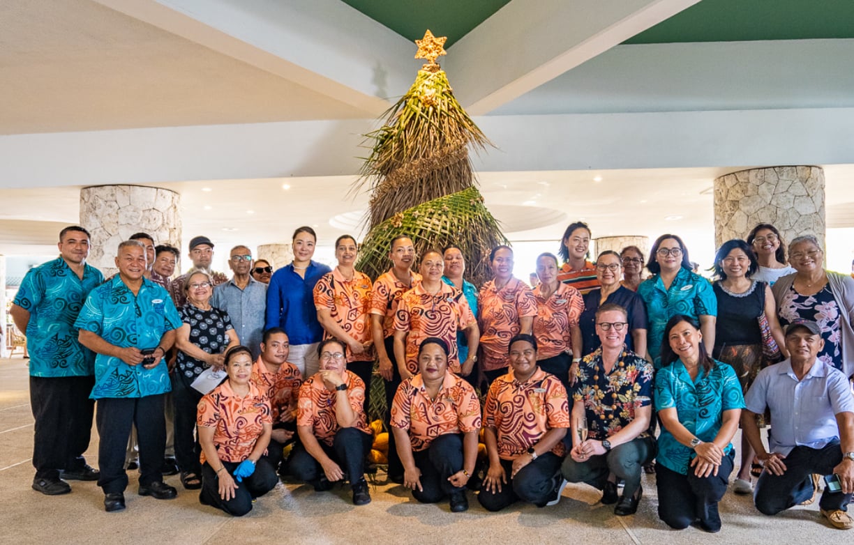 Members of the Hyatt Regency Saipan family pose next to their tropical Christmas tree on Saturday.