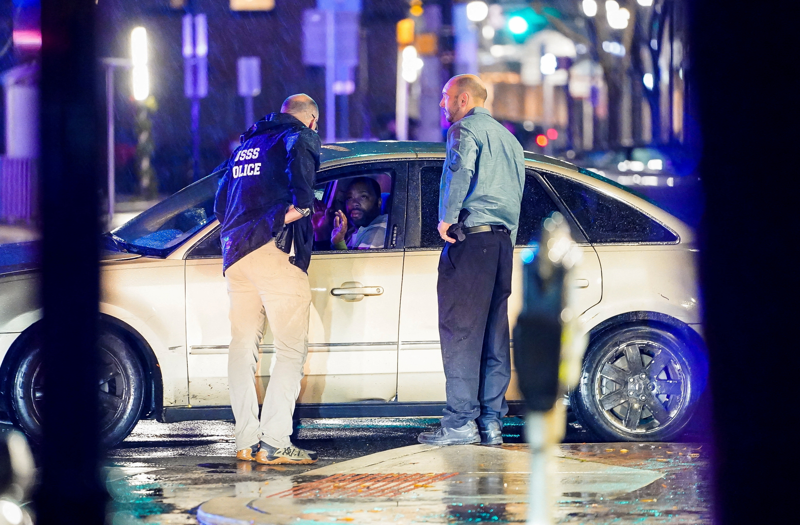 Members of the United States Secret Service speak to the driver of the vehicle that crashed into a Secret Service SUV that was blocking the street as U.S. President Joe Biden exited his campaign headquarters, in Wilmington, Delaware, U.S. December 17, 2023. 