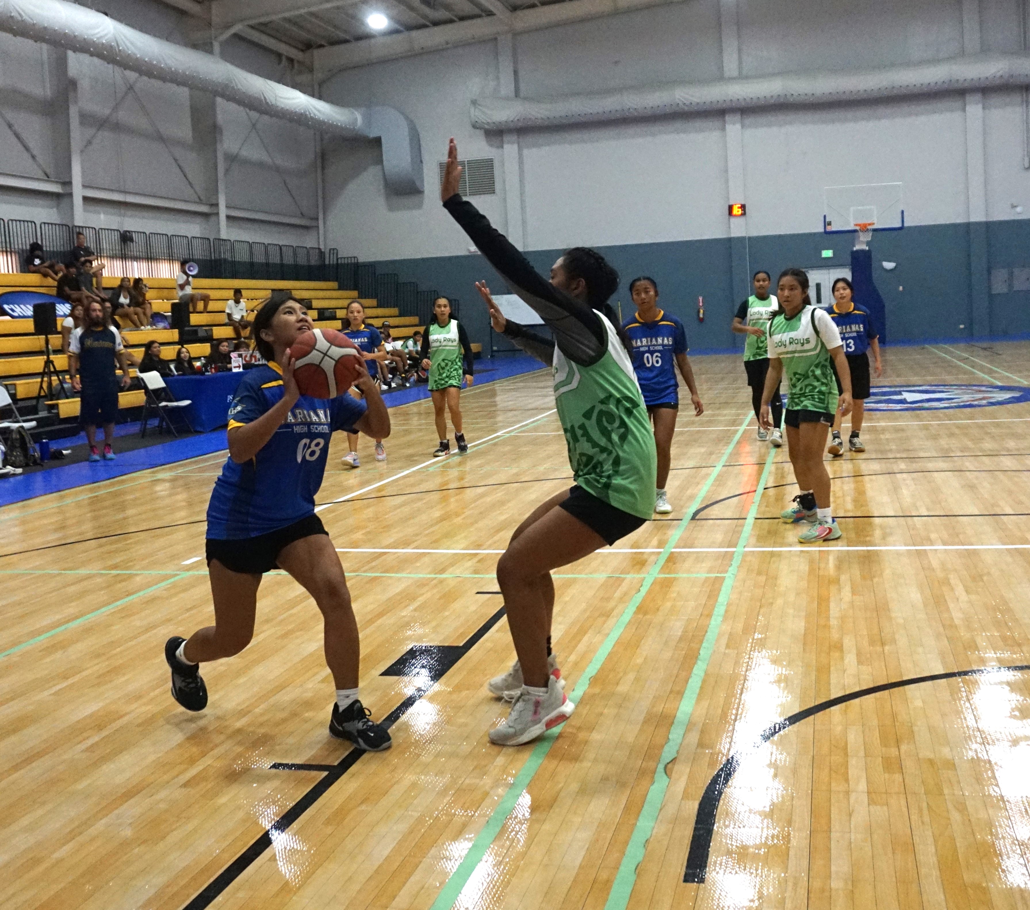 MHS' Angelina George goes up for the contested shot.