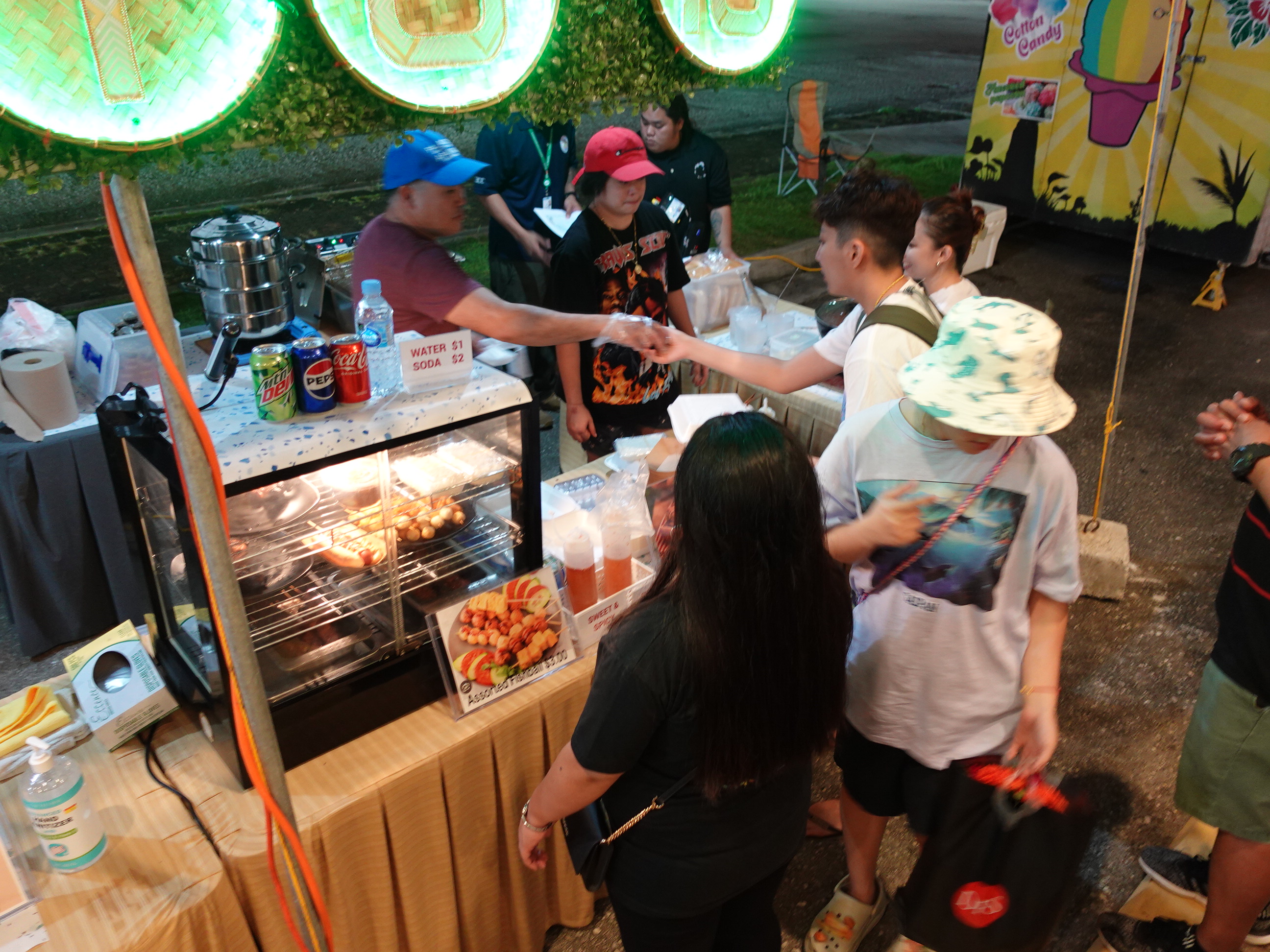 Cup Bap serves customers at the 19th Annual Christmas in the Marianas on Dec. 9, 2023, at T Galleria in Garapan, Saipan. 