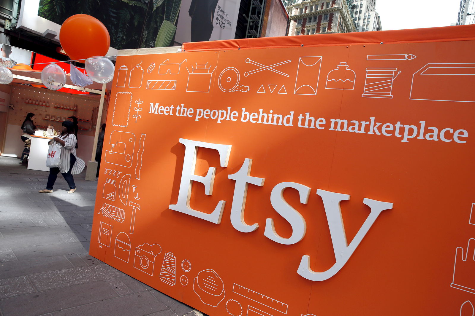 A sign advertising the online seller Etsy Inc. is seen outside the Nasdaq market site in Times Square following Etsy's initial public offering (IPO) on the Nasdaq in New York April 16, 2015. 