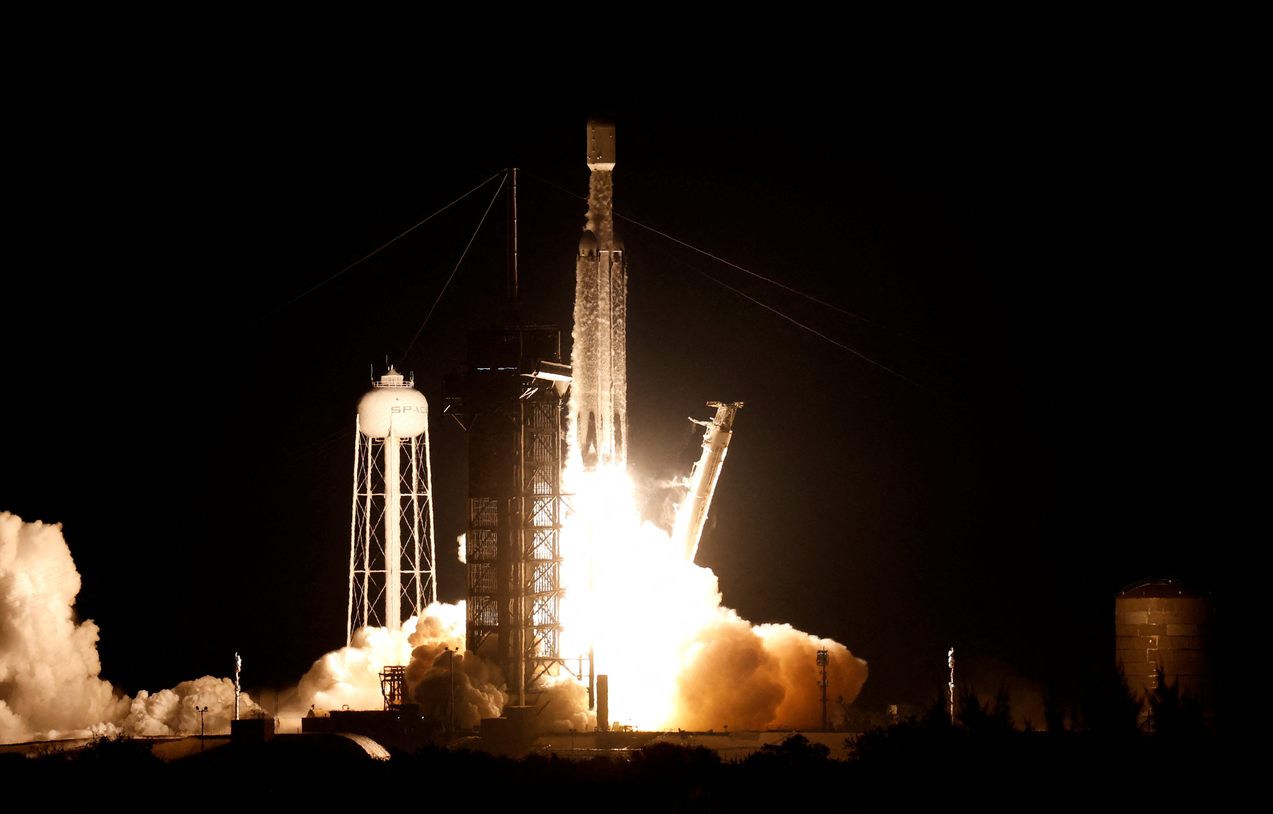 The U.S. military's secretive X-37B robot spaceplane lifts off on its seventh mission to orbit, the vehicle's first launch atop a SpaceX Falcon Heavy rocket capable of lofting it far higher than ever before from the Kennedy Space Center in Cape Canaveral, Florida, U.S., December 28, 2023. 