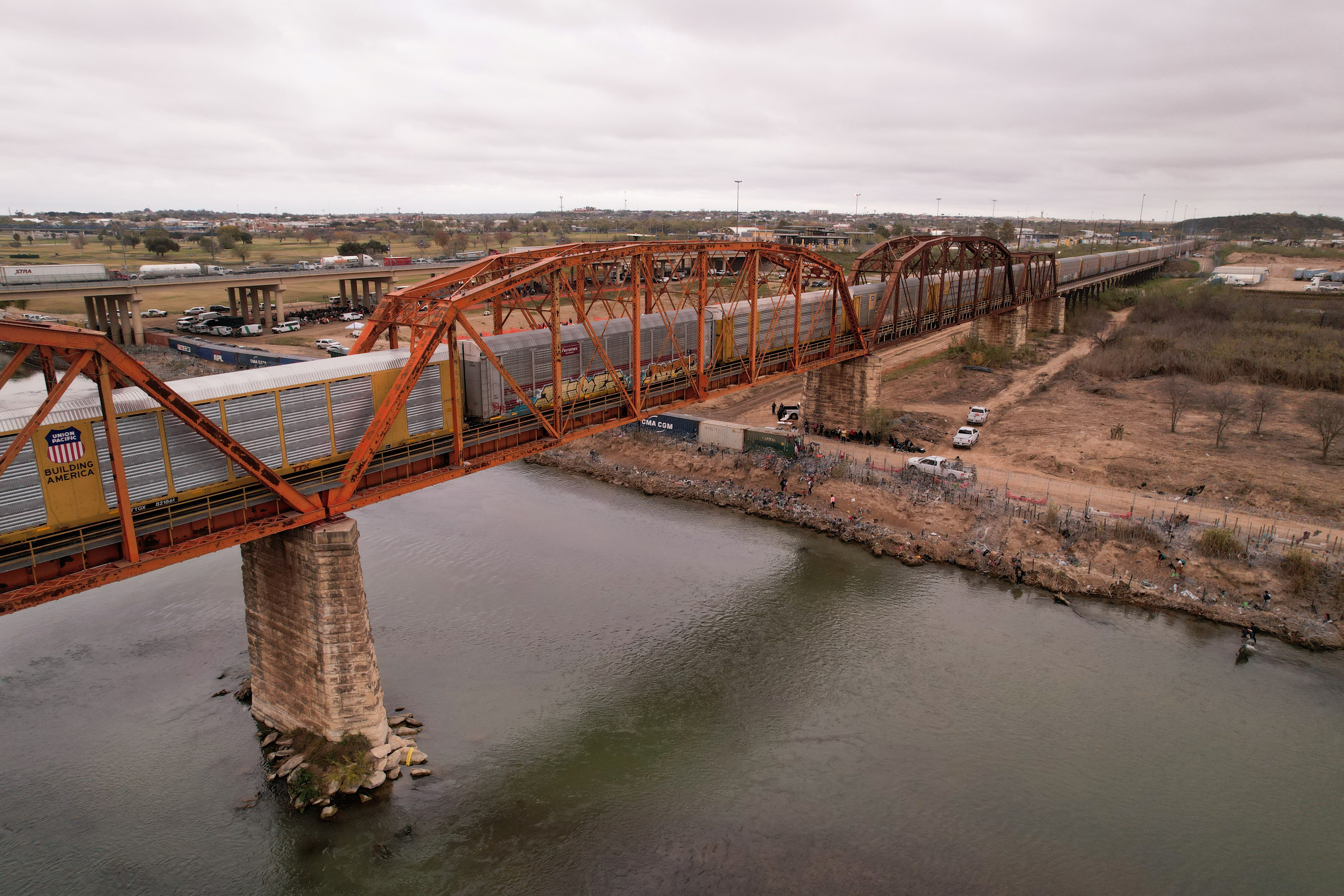 A freight train crosses the border between Mexico and the United States after a five-day suspension due to U.S. authorities closing railway bridges in Eagle Pass and El Paso, Texas, in order to redirect personnel to stop an increase in the migration, as seen from Piedras Negras, Cohauila, Mexico December 22, 2023. 