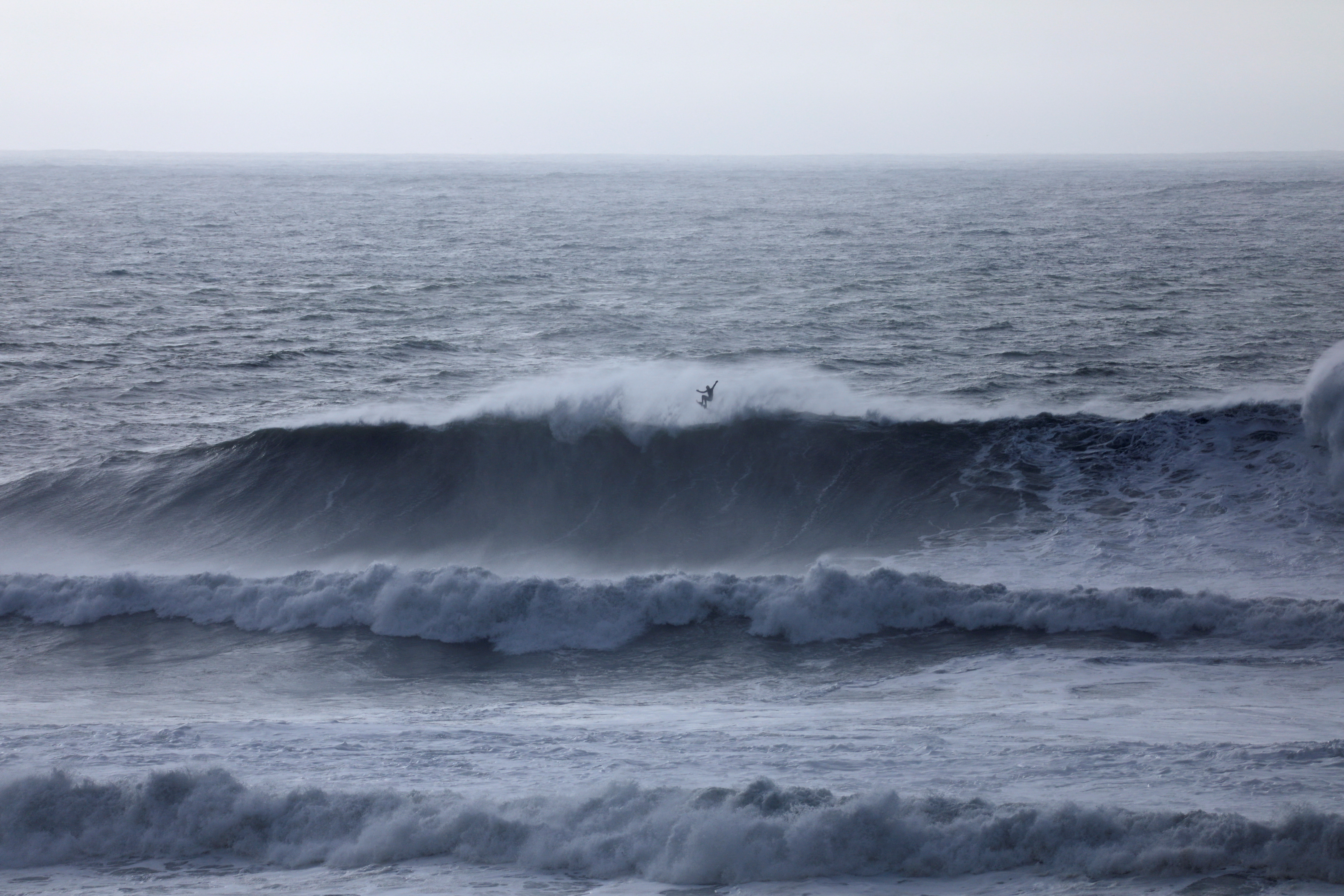 A surfer catches some air off a wave at Mavericks Beach near Half Moon Bay, California, U.S., December 28, 2023. 