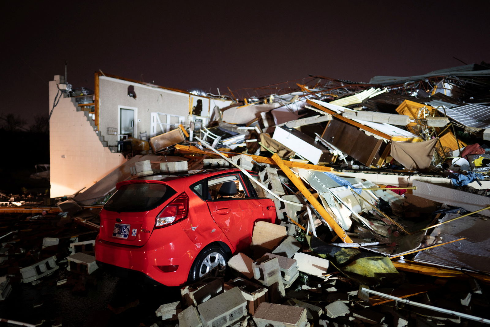 A car is buried under rubble on Main Street after a tornado hit Hendersonville, Tennessee, U.S. December 9, 2023. 