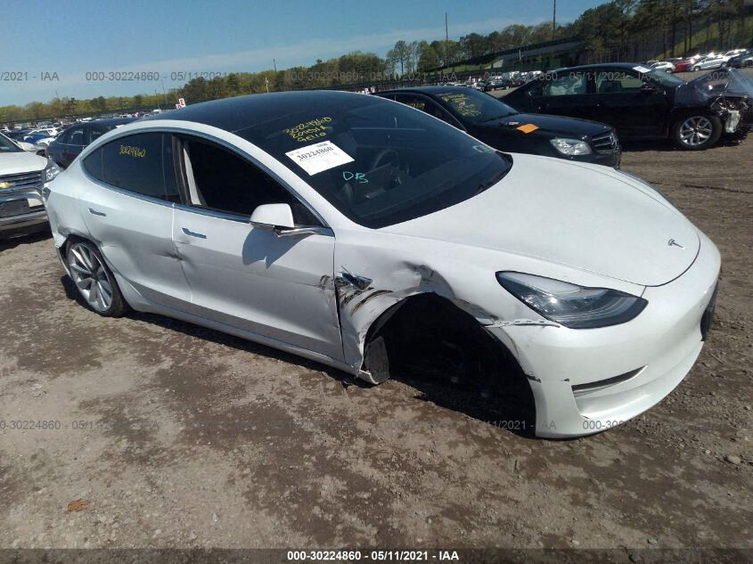 An image from car-auction website Stat.vin shows a 2020 Tesla Model 3 that was salvaged after an April 2021 accident in which, according to Tesla records, the vehicle's front wheel detached at 60 mph. 