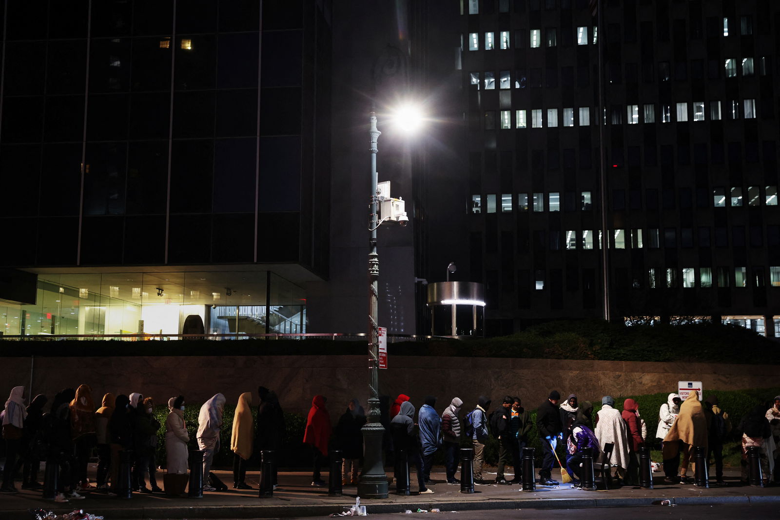 Immigrants wait in line outside the Federal Plaza Immigration Court in New York City, U.S., November 2, 2023. 