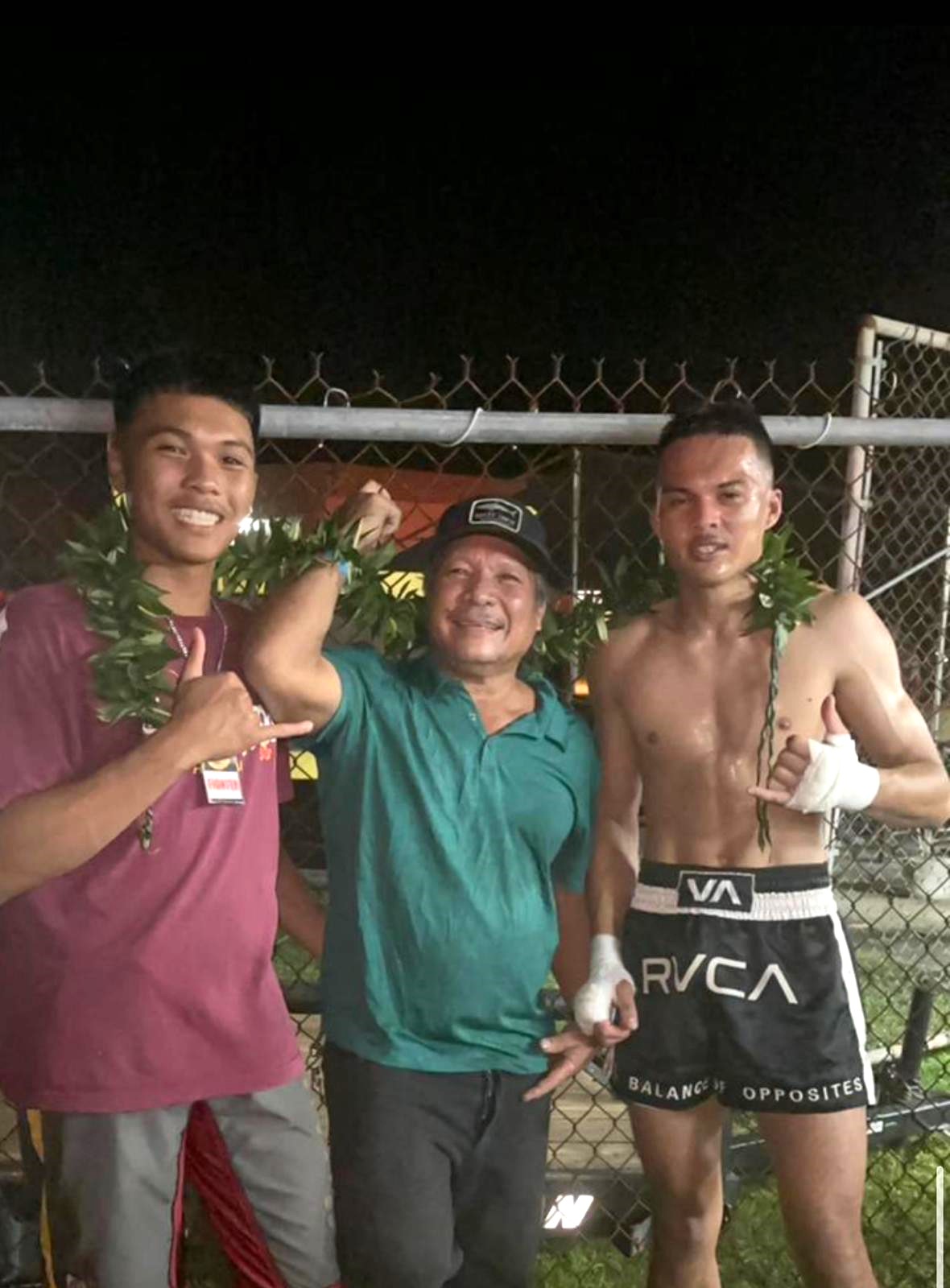 Andres Camacho, right, poses for a photo with his brother Jose and father Froilan after winning his Ring of Fire boxing match at the Garapan Central Park roundhouse on Saturday.