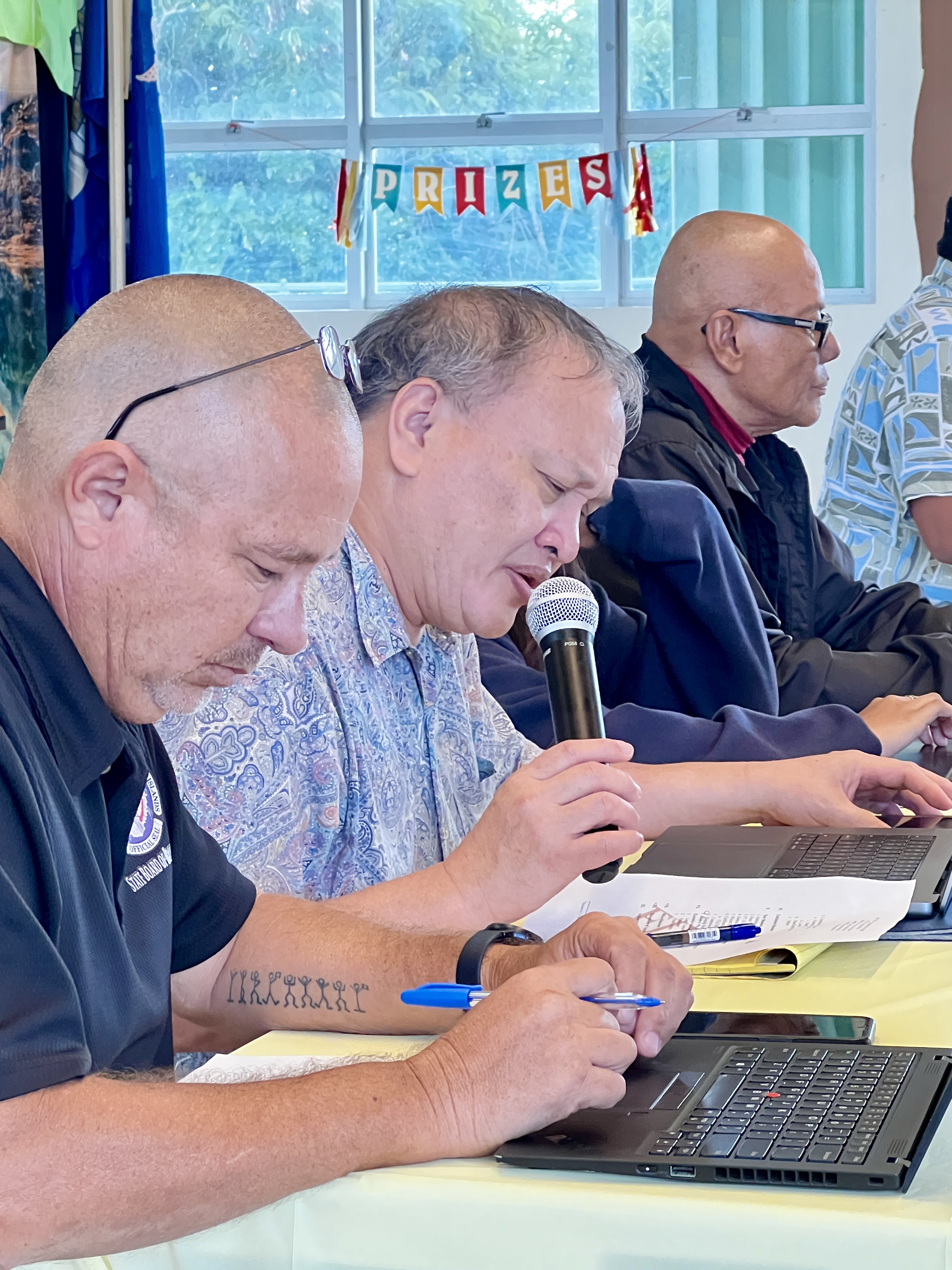 Board of Education Member Andrew L. Orsini speaks while Secretary/Treasurer Gregory Pat Borja and Vice Chairman Herman Atalig listen.