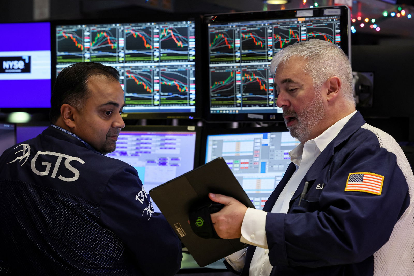 Traders work on the floor at the New York Stock Exchange (NYSE) in New York City, U.S., December 7, 2023. 