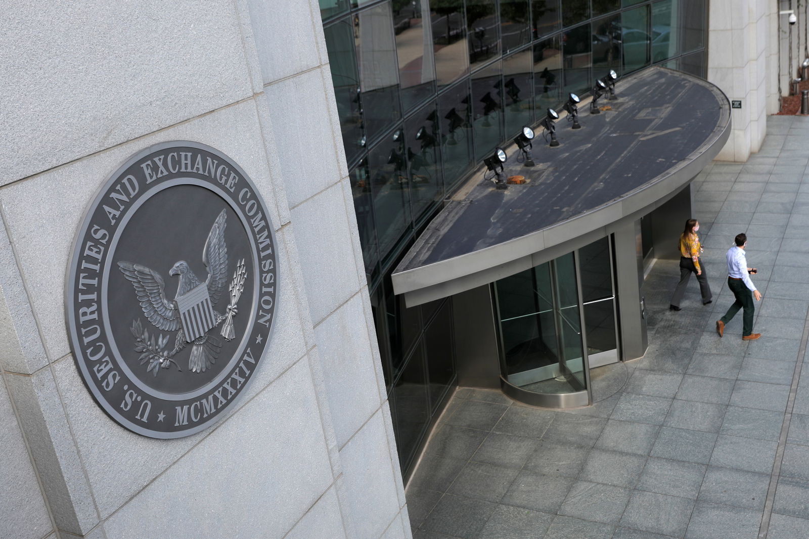 People exit the headquarters of the U.S. Securities and Exchange Commission (SEC) in Washington, D.C., U.S., May 12, 2021. 