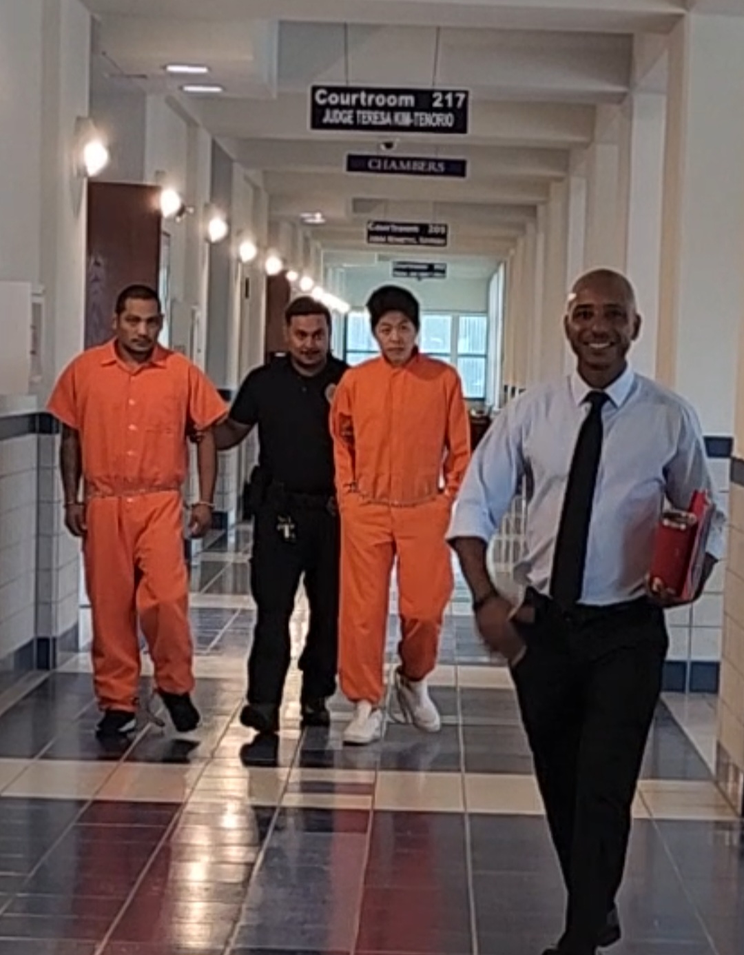 Alexander Borja, left, and Brian Lee, 2nd right, are escorted by a Corrections officer at the courthouse on Monday morning. Also in photo is Chief Prosecutor Chester Hinds, right.