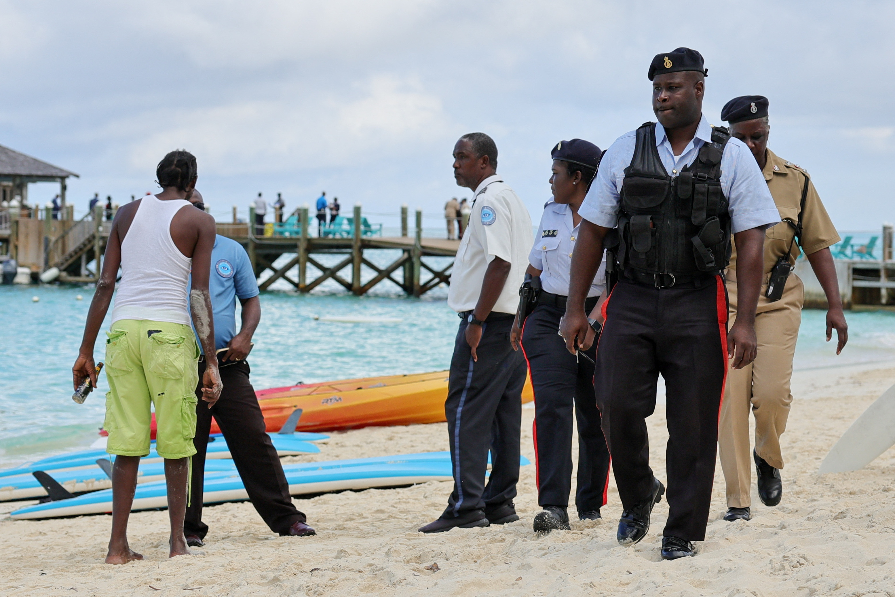 Police officers walk on the beach after what police described as a fatal shark attack against a tourist at Sandals Royal Bahamian resort, in Nassau, Bahamas December 4, 2023. 