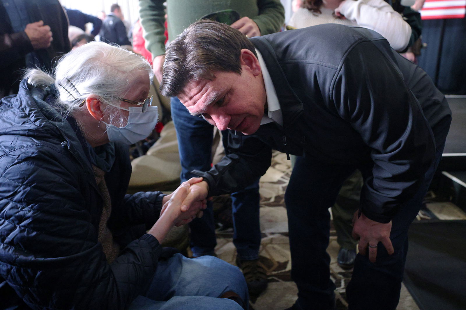 Republican presidential candidate Florida Governor Ron DeSantis listens to an audience member at a Never Back Down campaign stop in Concord, New Hampshire, U.S., December 15, 2023. 