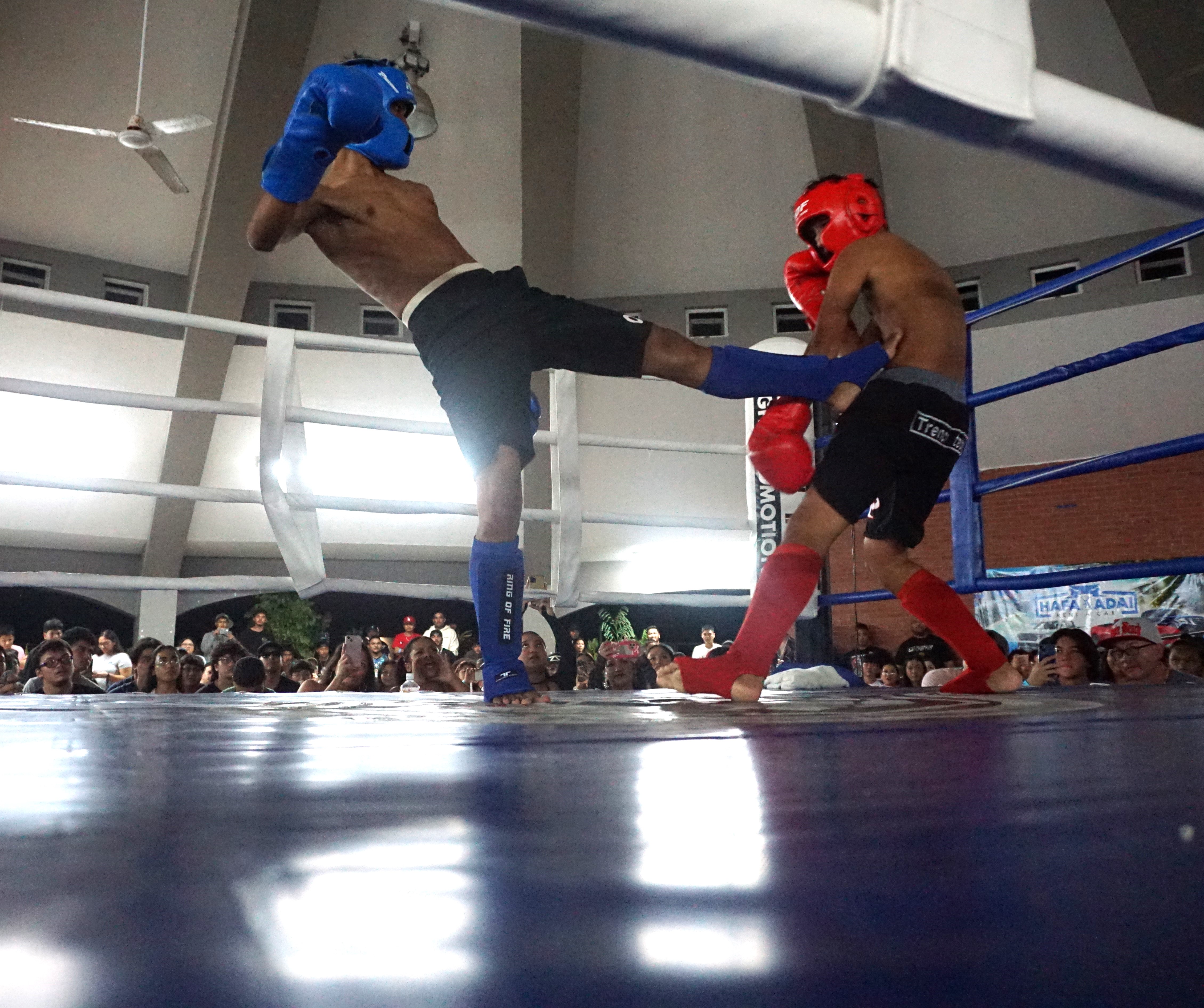 Angelo Pulido connects a body kick against Phil Gregorio during their Ring of Fire kickboxing match  at the Garapan Central Park round house on Saturday.