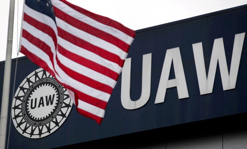 An American flag flies in front of the United Auto Workers union logo on the front of the UAW Solidarity House in Detroit, Michigan, September 8, 2011. 