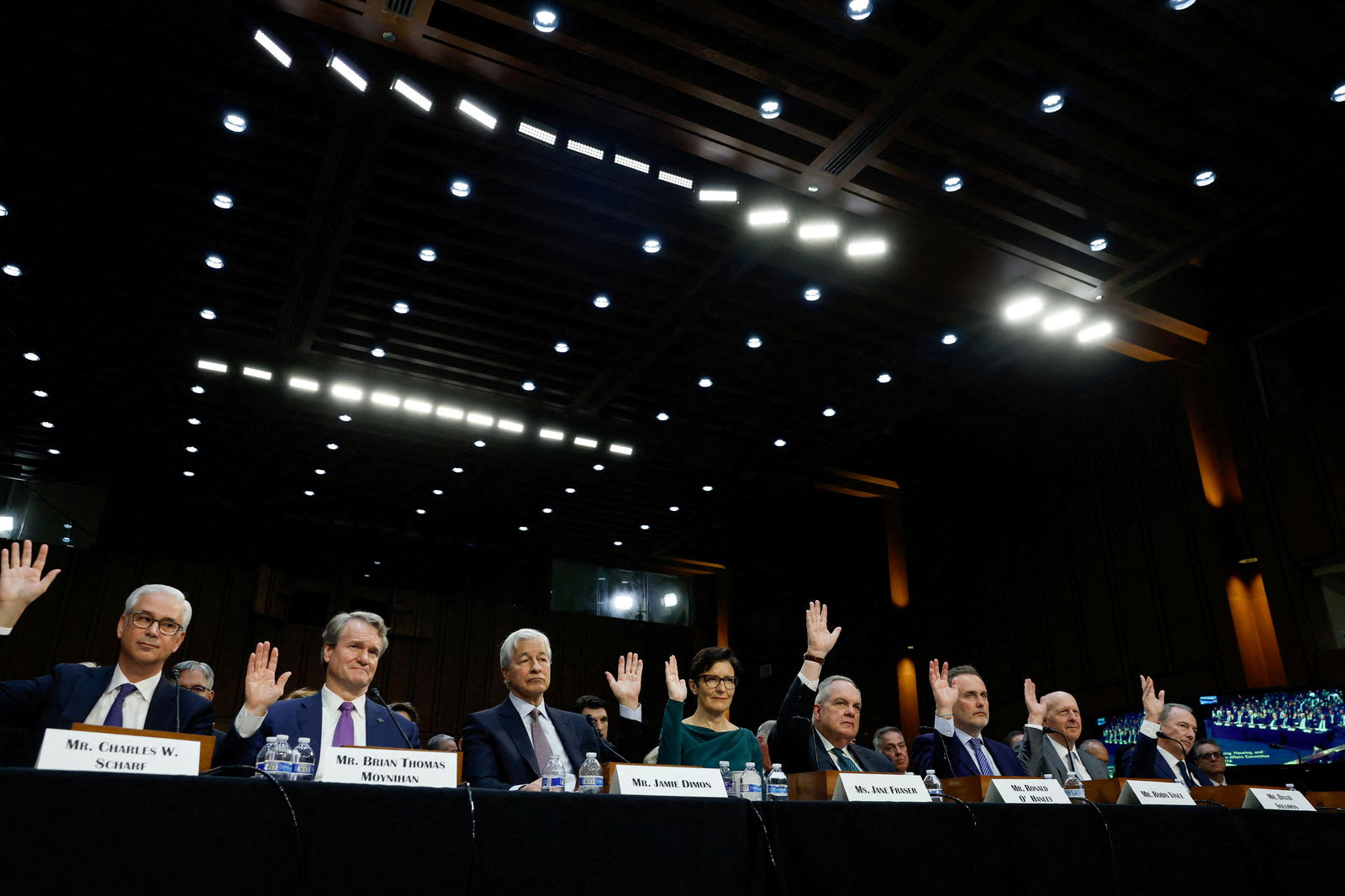Wells Fargo CEO and President Charles W. Scharf, Bank of America Chairman and CEO Brian Thomas Moynihan, JPMorgan Chase Chairman and CEO Jamie Dimon, Citigroup CEO Jane Fraser, State Street CEO Ronald O'Hanley, BNY Mellon CEO Robin Vince, Goldman Sachs CEO David Solomon and Chairman and CEO of Morgan Stanley James Gorman raise their hands during a U.S. Senate Banking, Housing and Urban Affairs Committee oversight hearing on Wall Street firms, on Capitol Hill in Washington, U.S., December 6, 2023. 