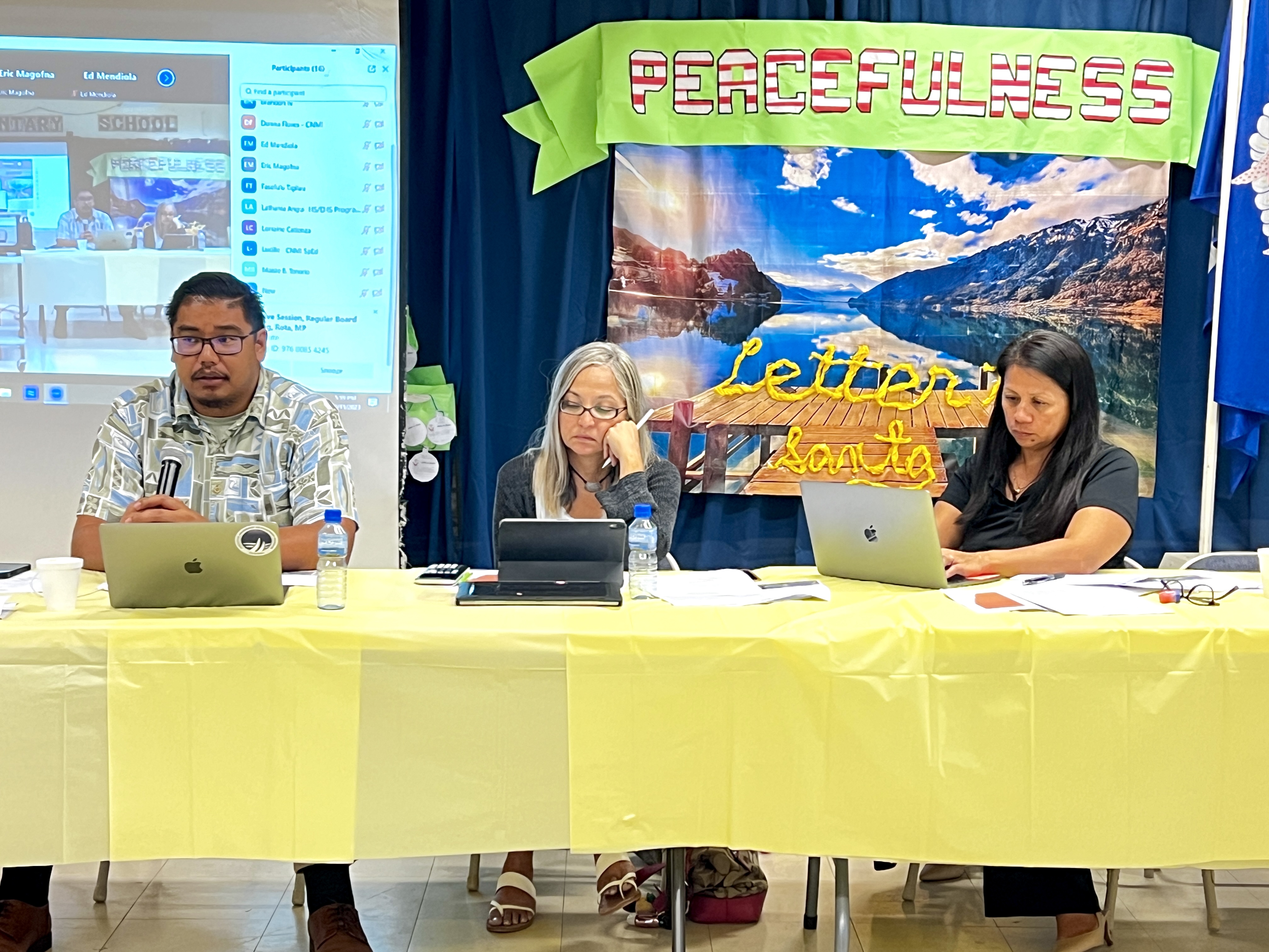 Board of Education Chairperson Antonio L. Borja, left, speaks while Teacher Representative Dr. Dora B. Miura and Board Member Maisie B. Tenorio listen.