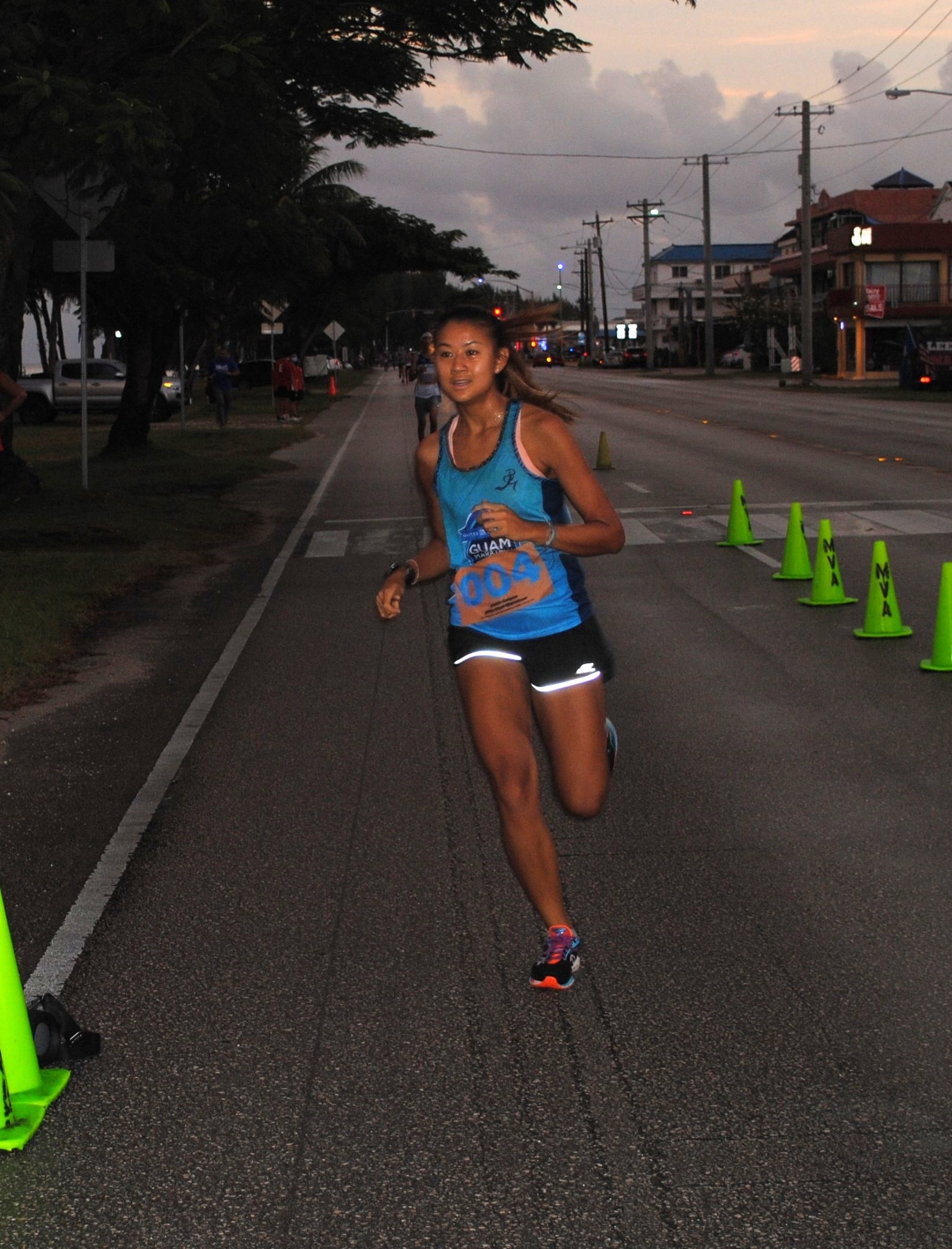 Tania Tan smiles as she crosses the finish line of Run Saipan's Run from 2021 on Beach Road in Oleai.