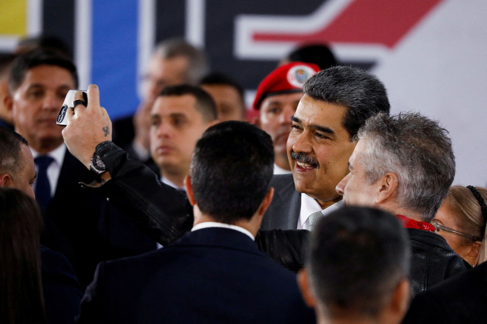 Venezuelan President Nicolas Maduro poses for a selfie with supporters during an event at the National Electoral Council (CNE) in Caracas, Venezuela, December 4, 2023. 