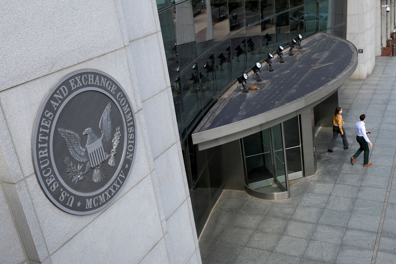 People exit the headquarters of the U.S. Securities and Exchange Commission (SEC) in Washington, D.C., U.S., May 12, 2021. 