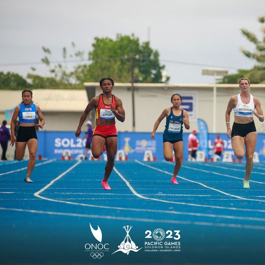 The NMI’s Casey Cruz, left, races in the 100m run prelims in the 2023 Pacific Games at the National Stadium on Monday.