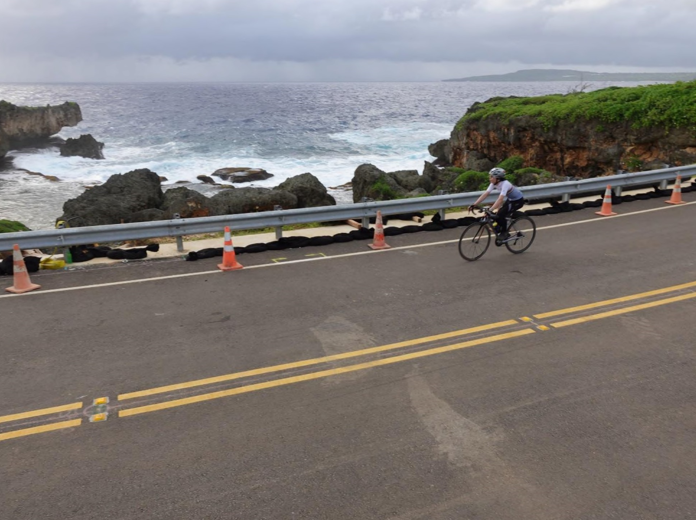 A cyclist passes Unai Nanasu beach while taking on the challenge of Hell of the Marianas on Saipan, Dec. 2,  2023. The annual  event  is  organized  by the Marianas Visitors  Authority and Northern  Mariana Islands Cycling Federation
